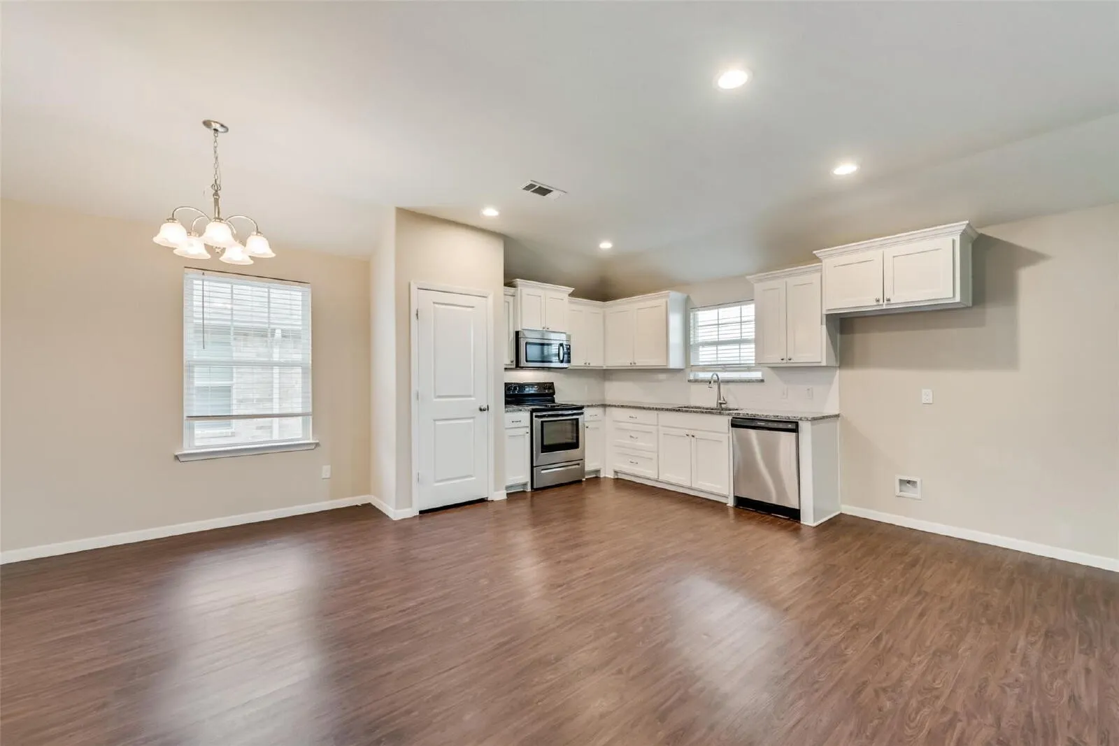 Open-concept living area with wood-finish flooring