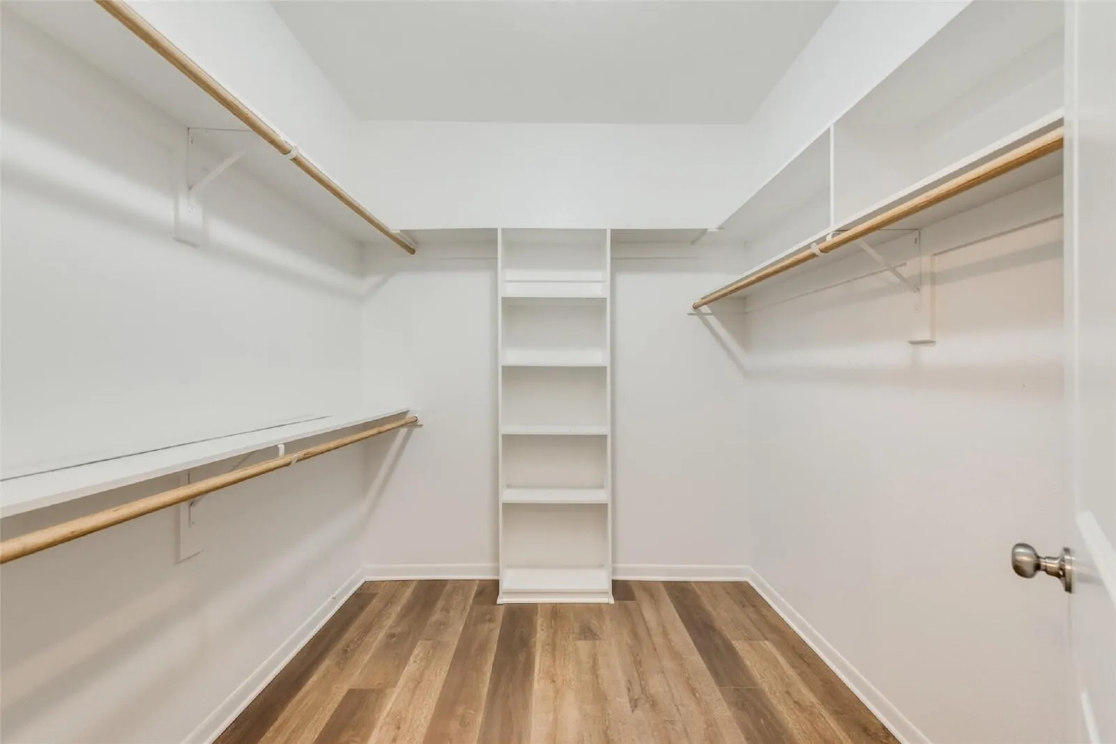 Wood-finish flooring, built-in shelving, and dual clothing rods