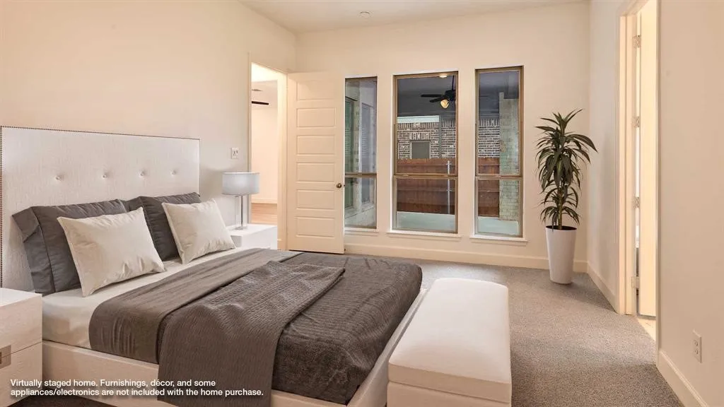 Plush carpeted flooring, a bank of three vertical windows, and a paneled interior door