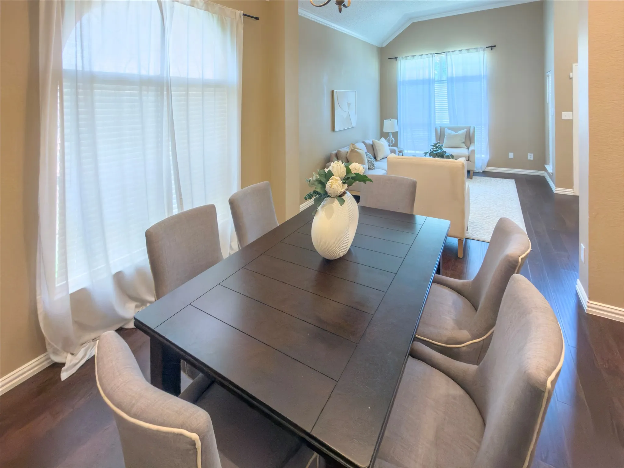 Wood-finish flooring throughout, vaulted ceiling, and crown molding