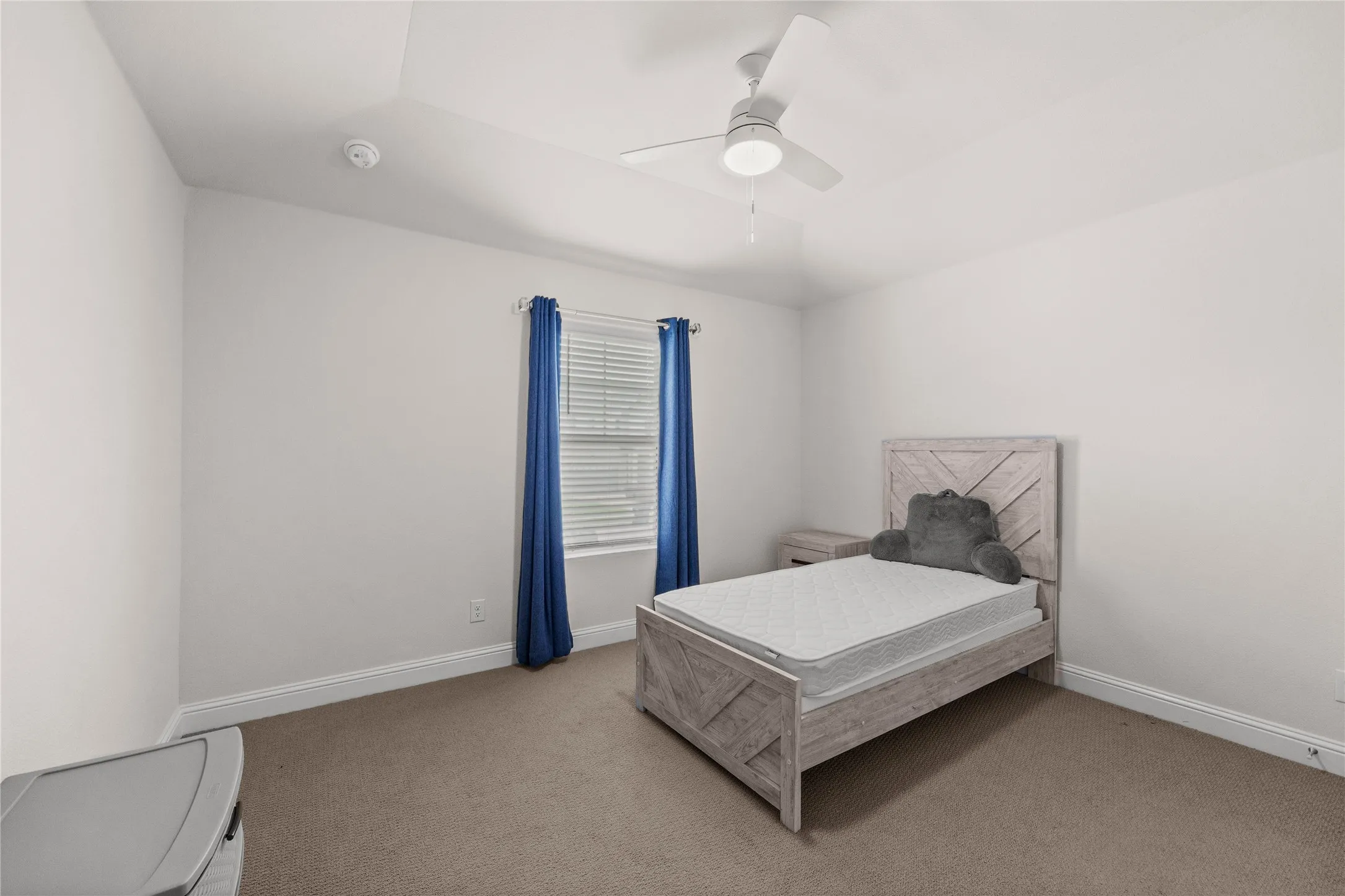 Wall-to-wall carpeting, window with blinds, ceiling fan with integrated lighting, and crown molding