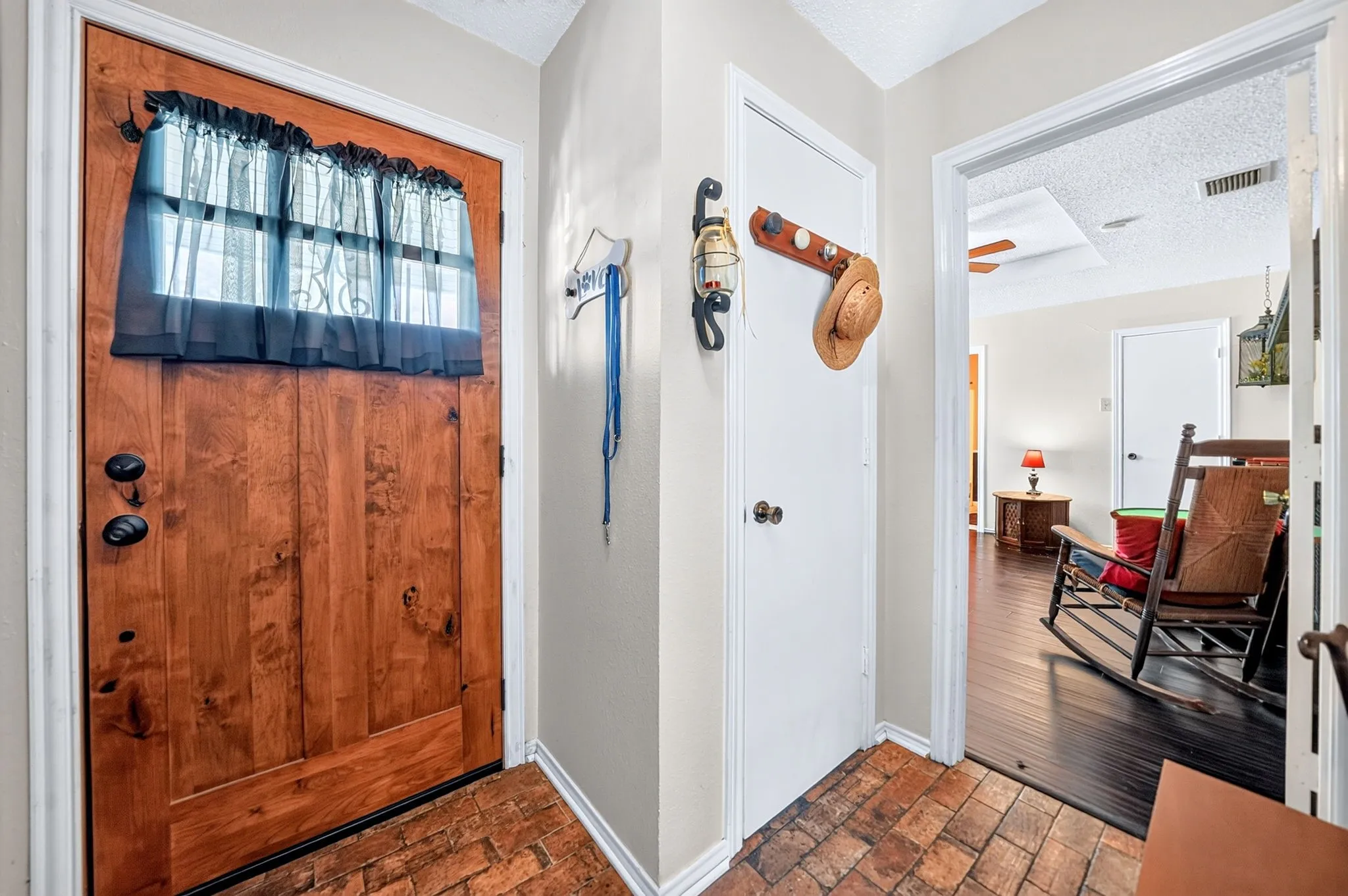Wood-finish entry door with clear glass transom