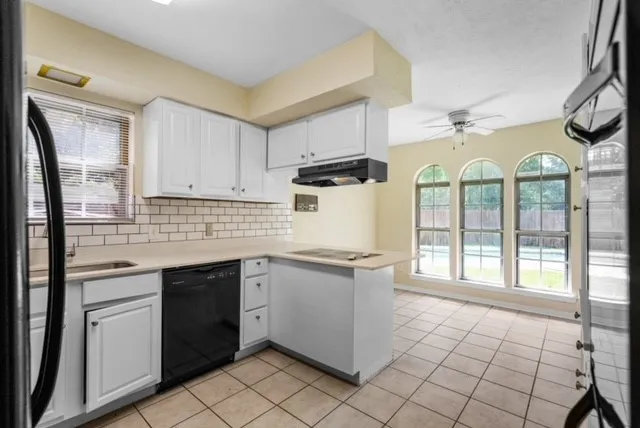 White shaker-style cabinetry with a subway tile backsplash