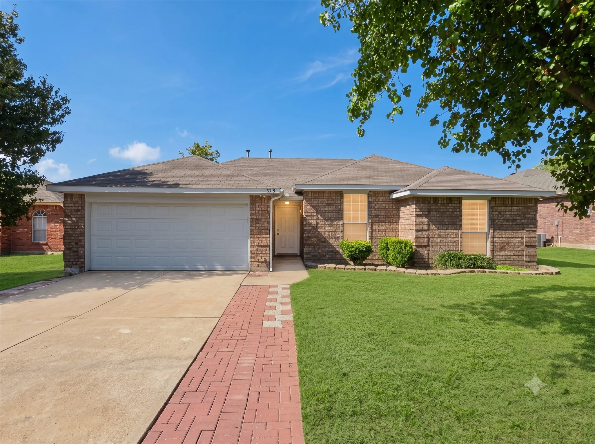 Brick exterior with a gabled roof and attached garage