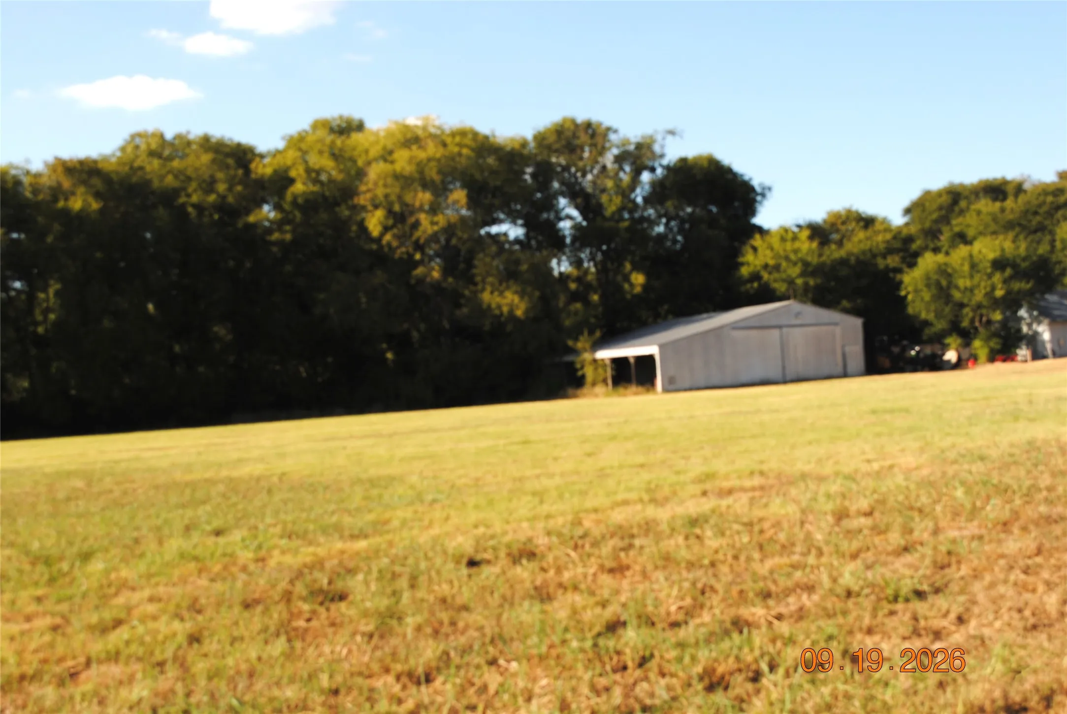 Large utility barn is near front corner of property.