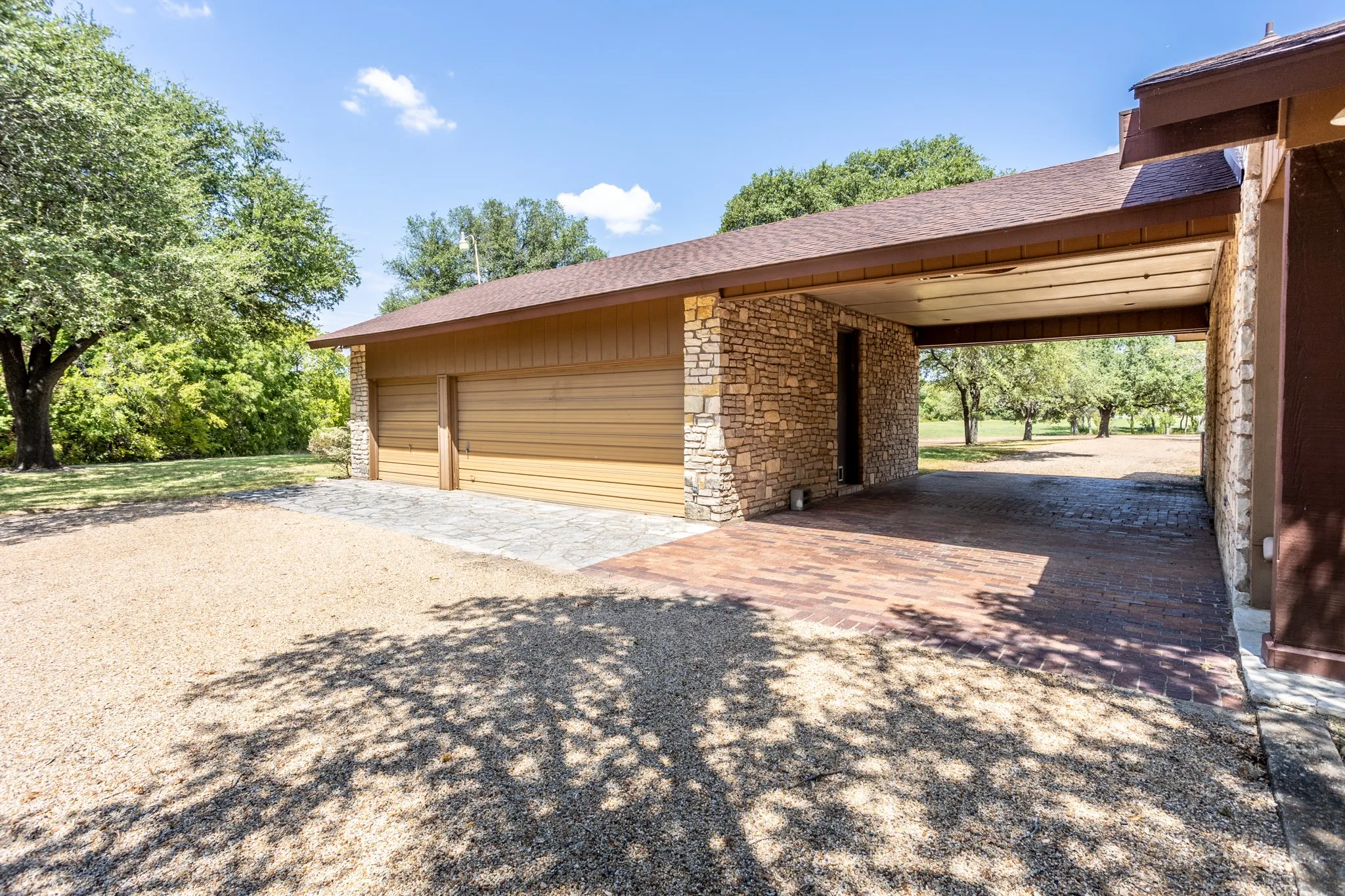 Three garages has rear enter for privacy plus carport