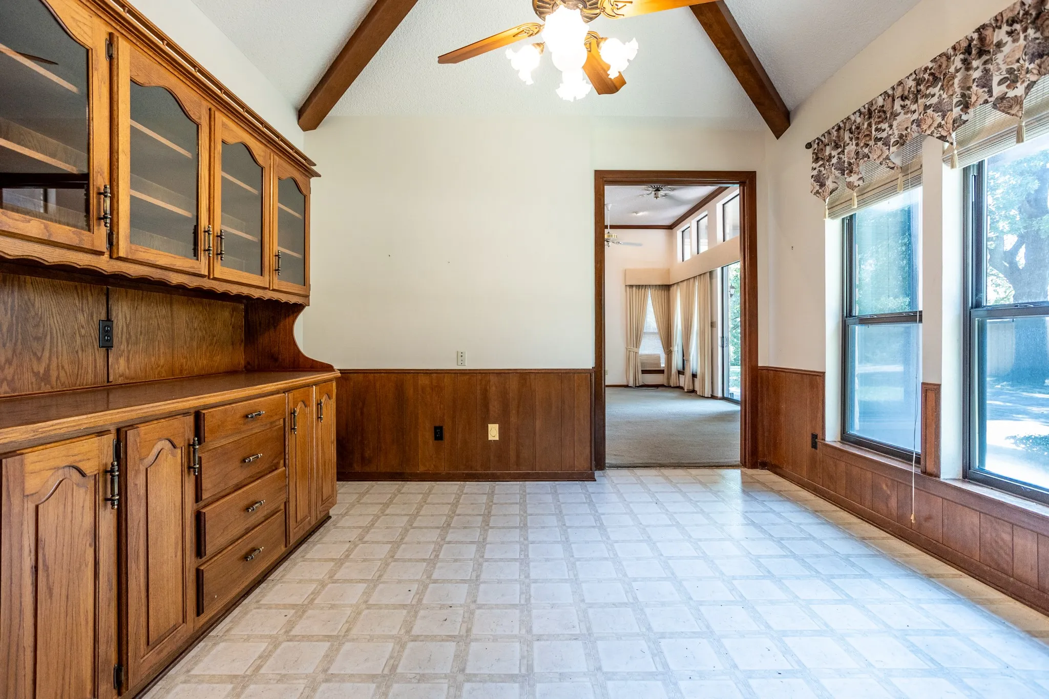 Breakfast room with bult in hutch has view toward back yard