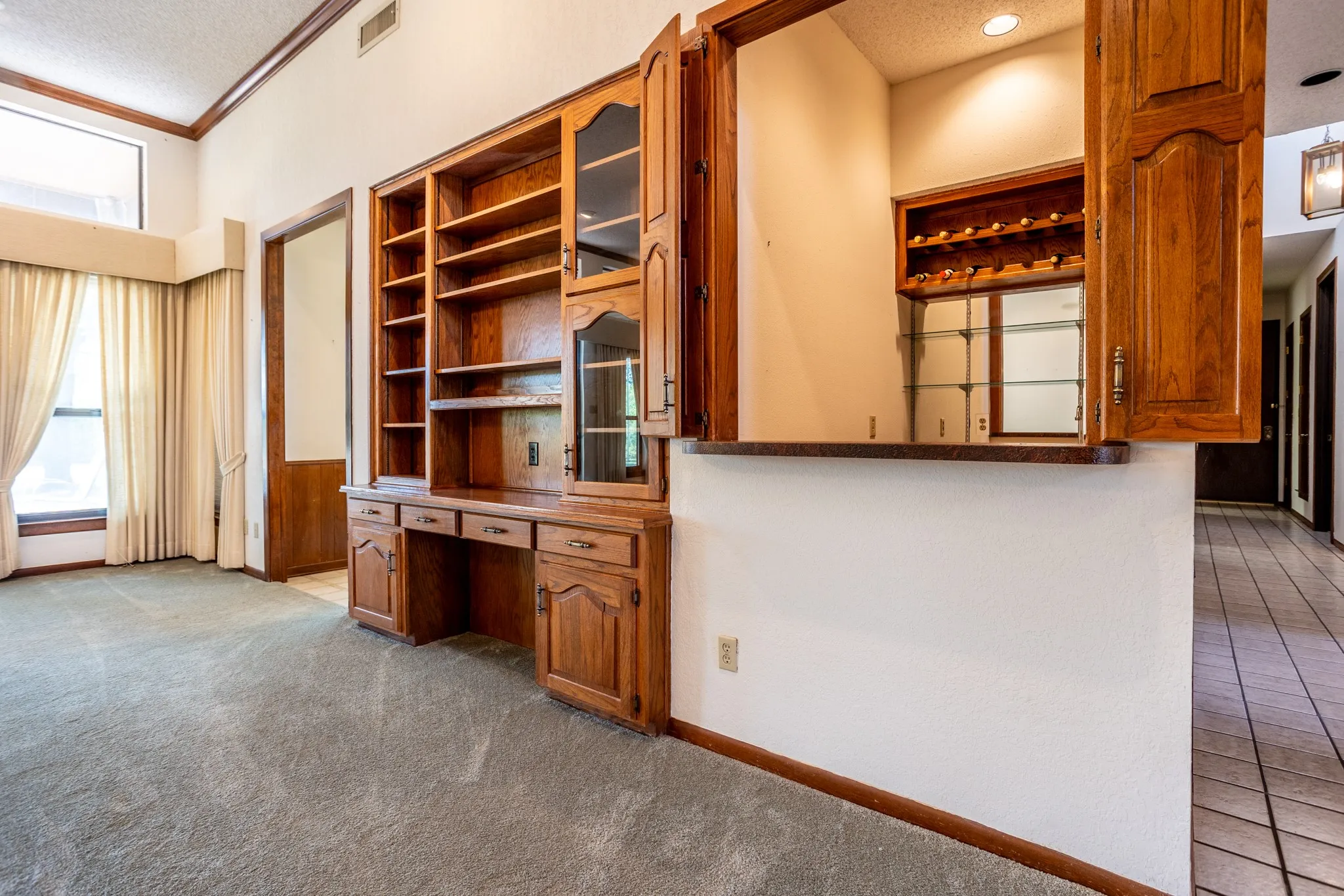 Built-in and wet bar also shows hall going toward side door.