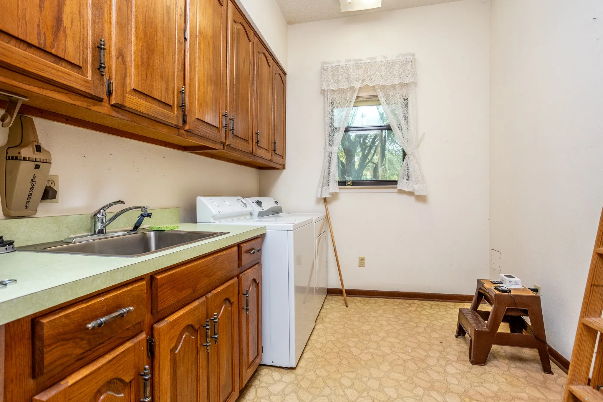 Utility offers storage and space for freezer.  Located by side door.
