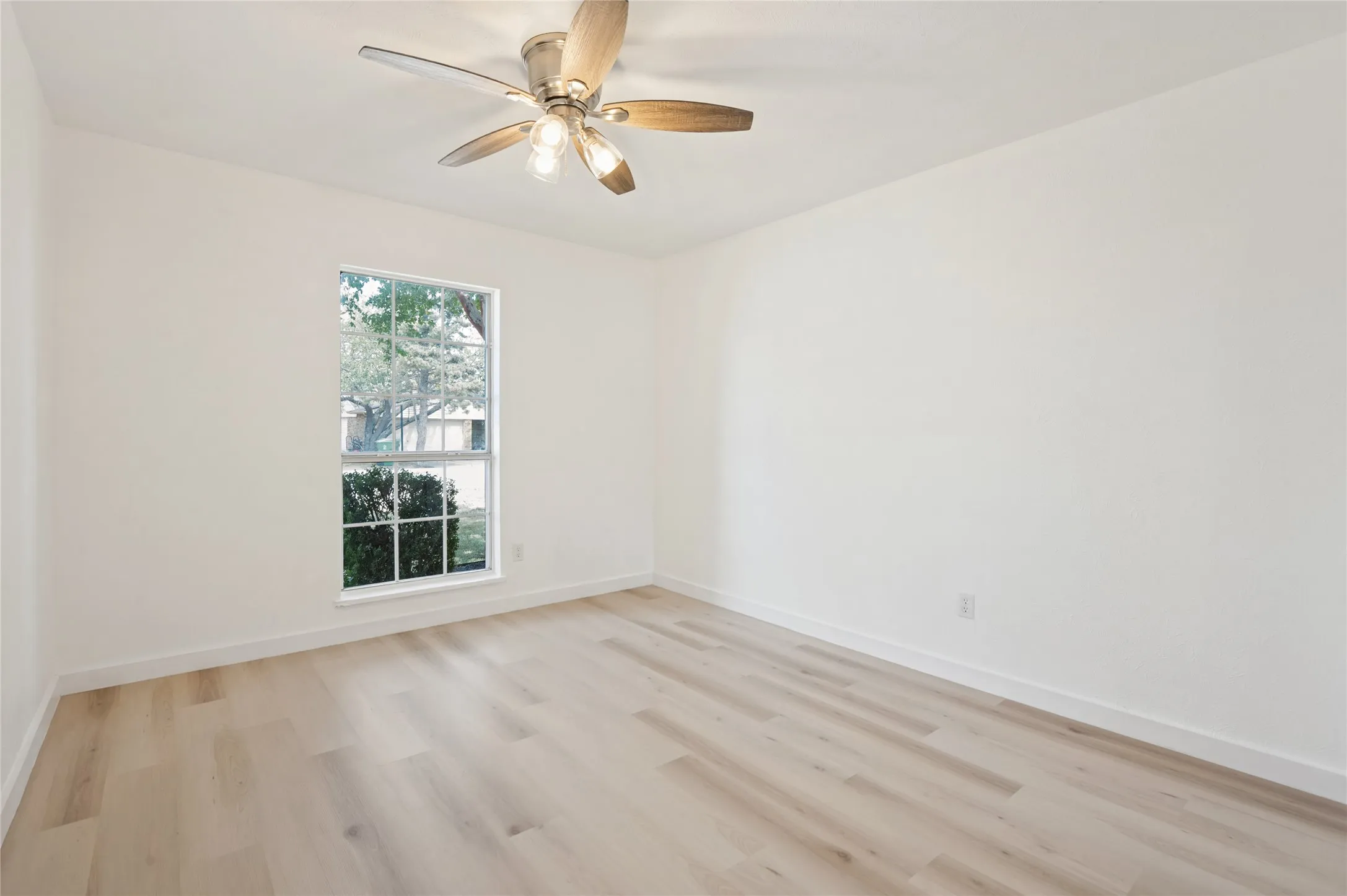 Wood-finish flooring with white walls and trim