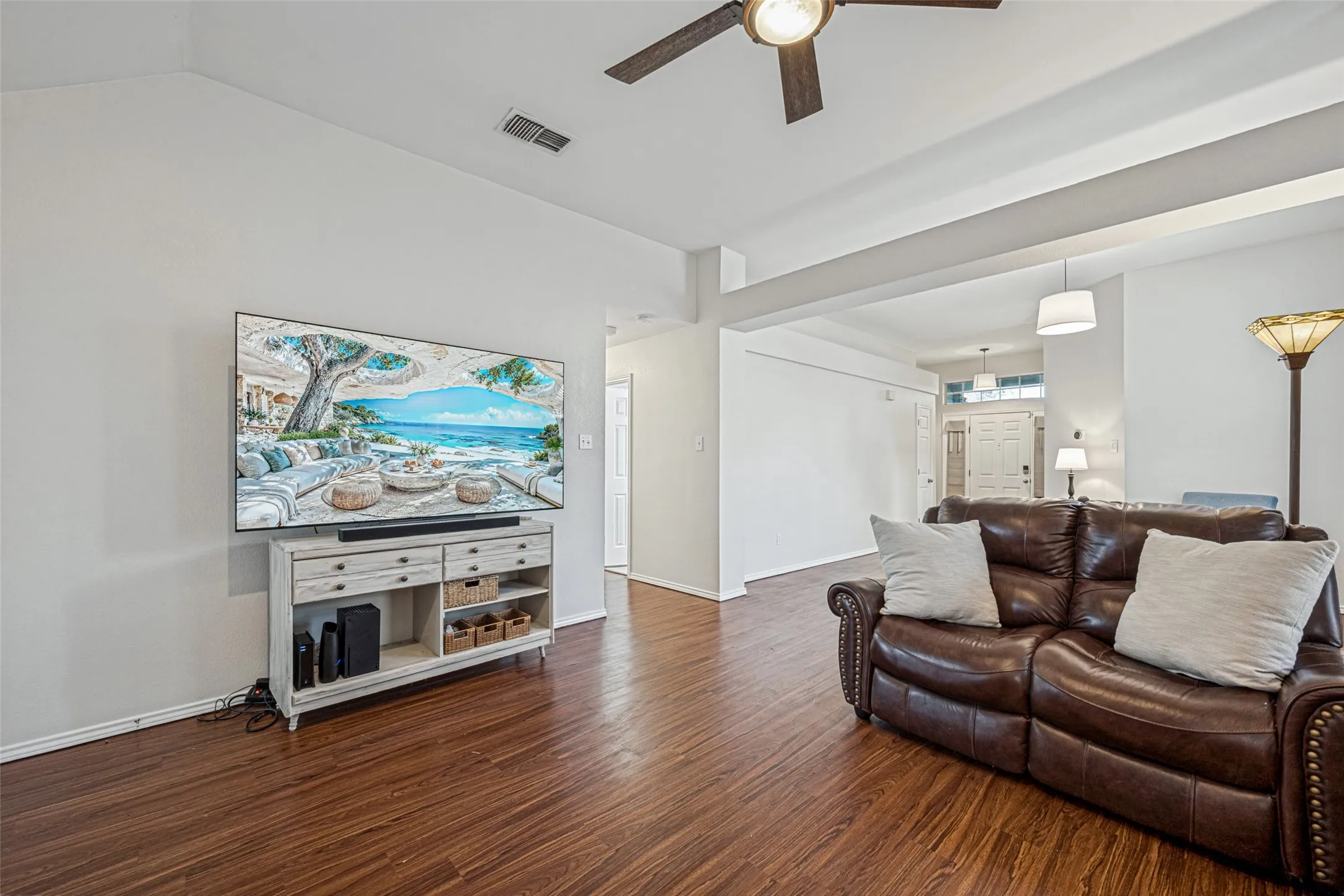 Wood-finish flooring throughout, vaulted ceiling, and recessed lighting