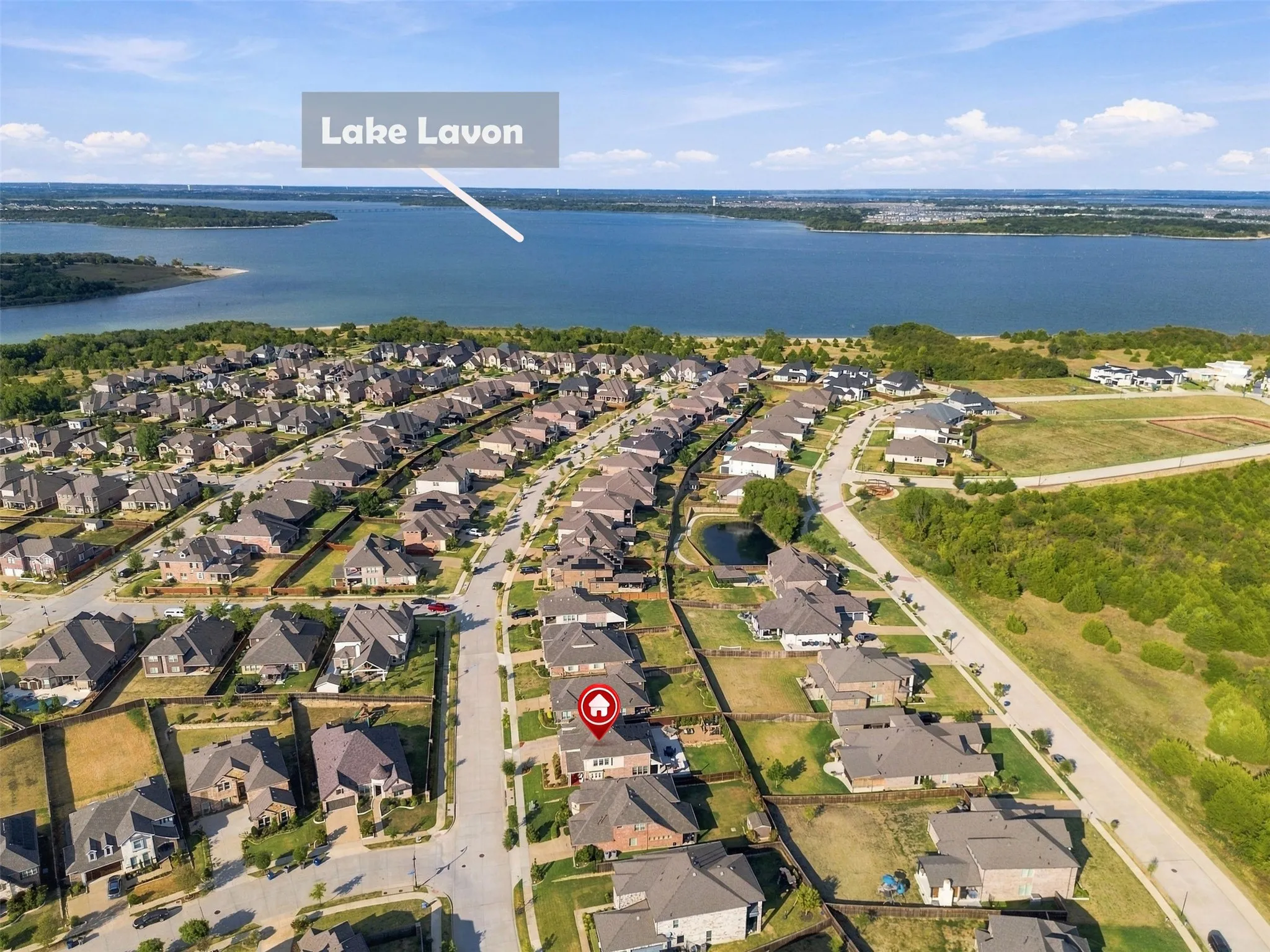 Aerial perspective showcasing a residential community and nearby Lake Lavon