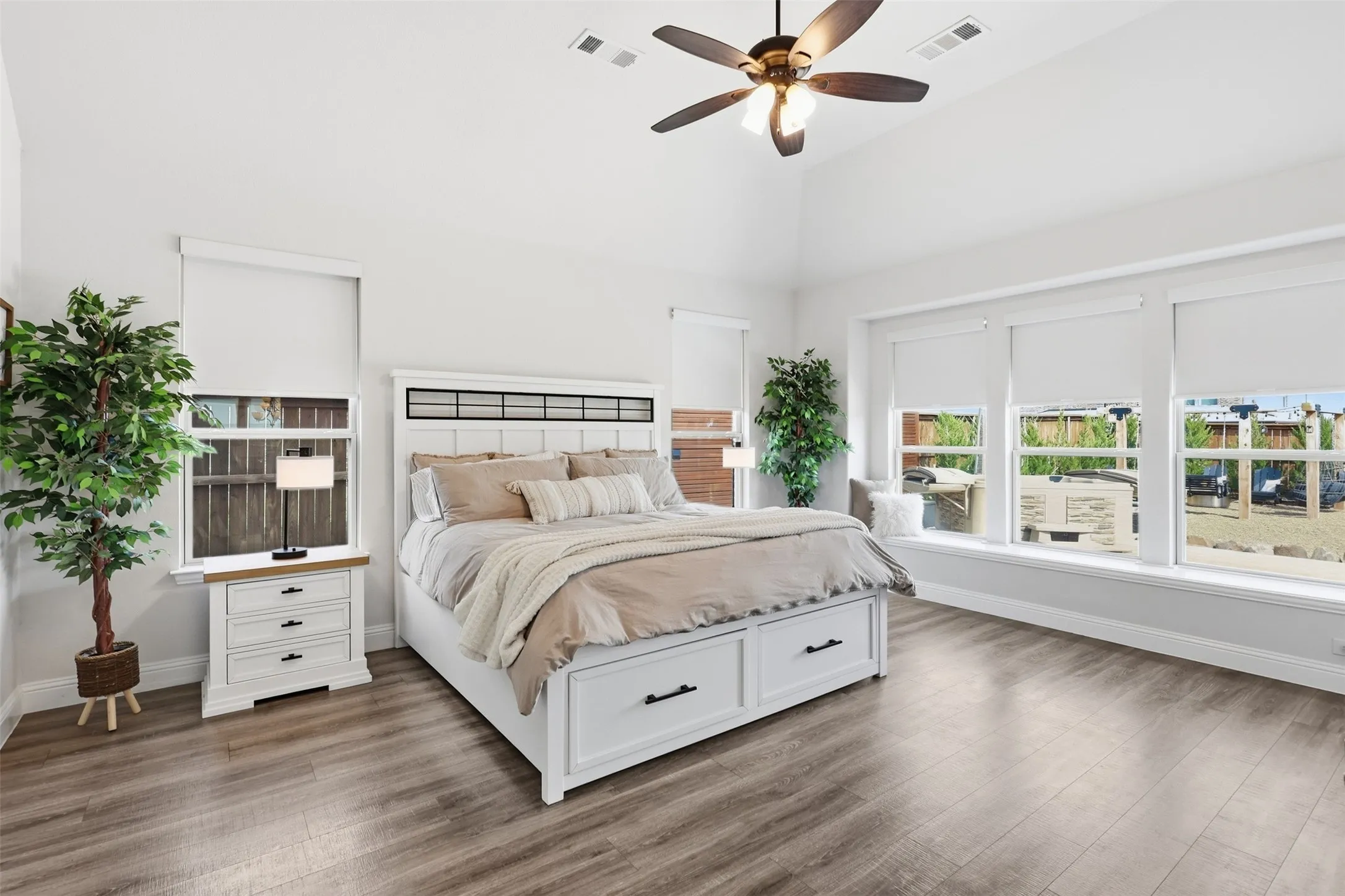 Primary suite on first floor with loads of natural light and vaulted ceiling. Includes custom built premium black out shades