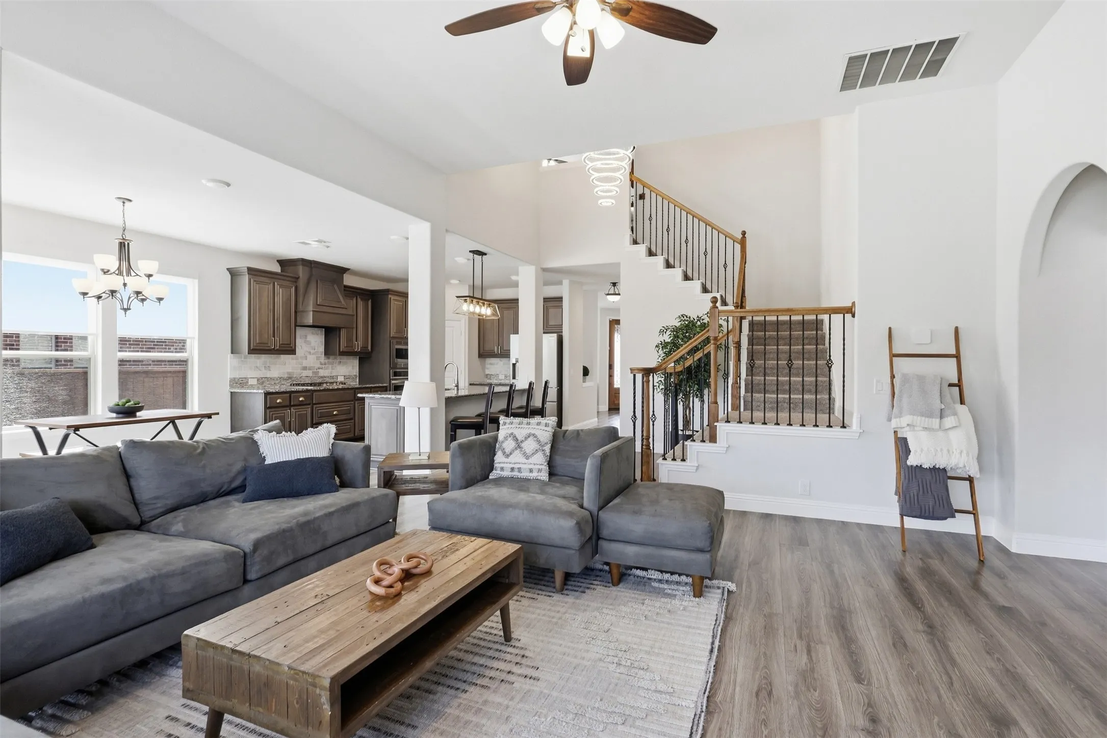 Spacious open floor plan on main level with kitchen and dining space overlooking the living room