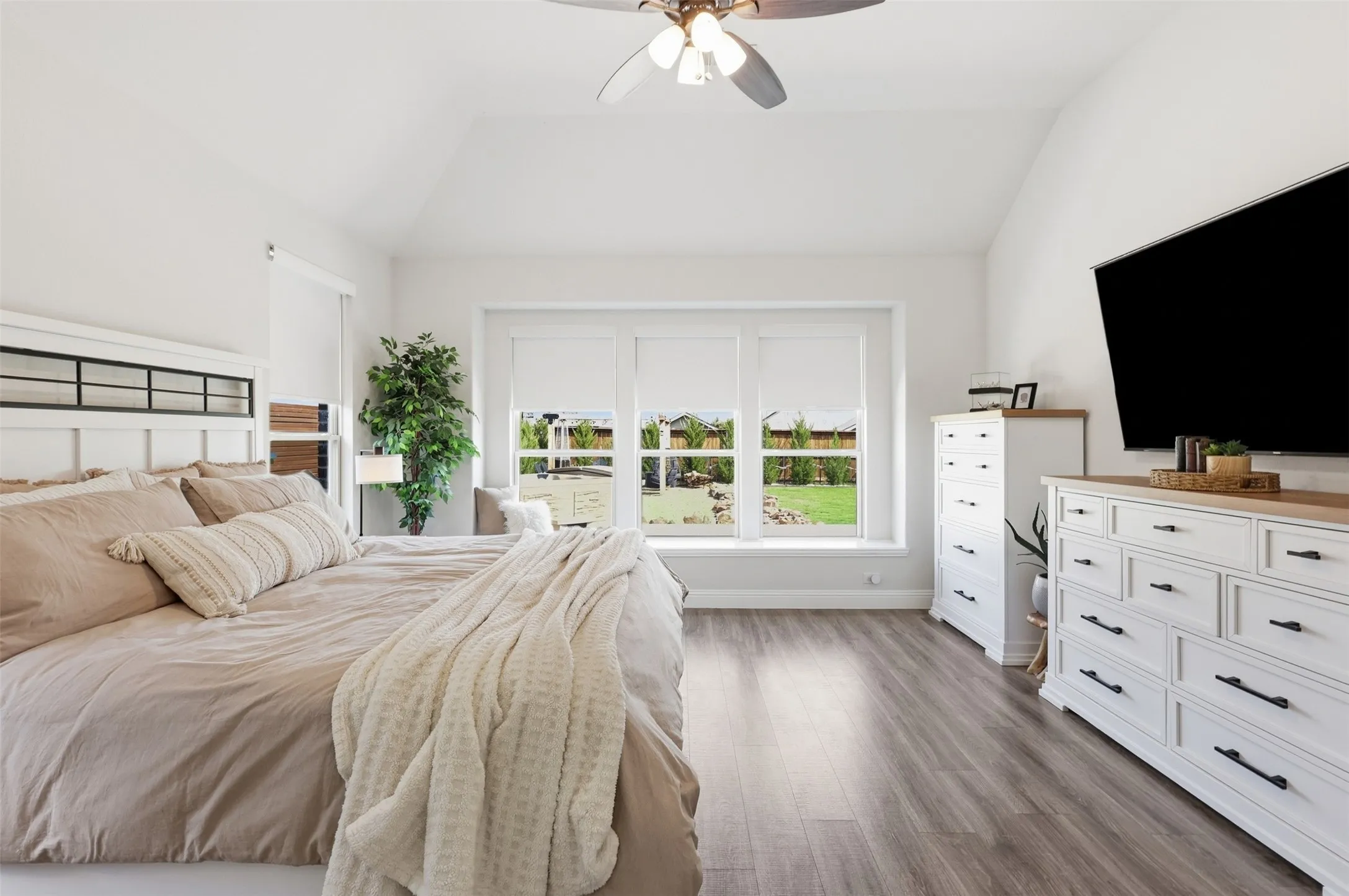 Primary suite with window seating overlooking the expansive back yard and hot tub