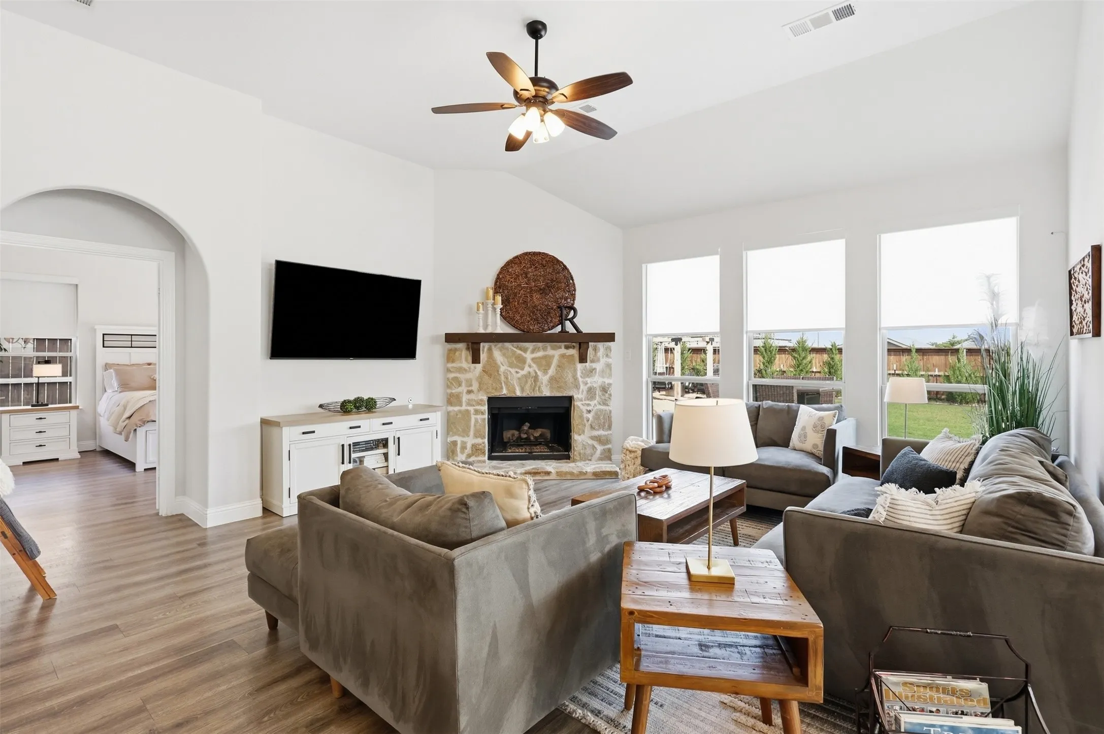 Open and bright living room just off the primary suite with gas fireplace