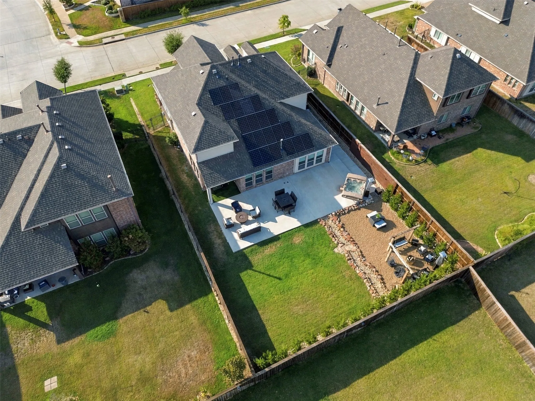Oversized yard perfect for entertaining with huge extended patio, hot tub, custom built fire pit, swing set and dry river bed lined with 20 high end spartan juniper privacy trees