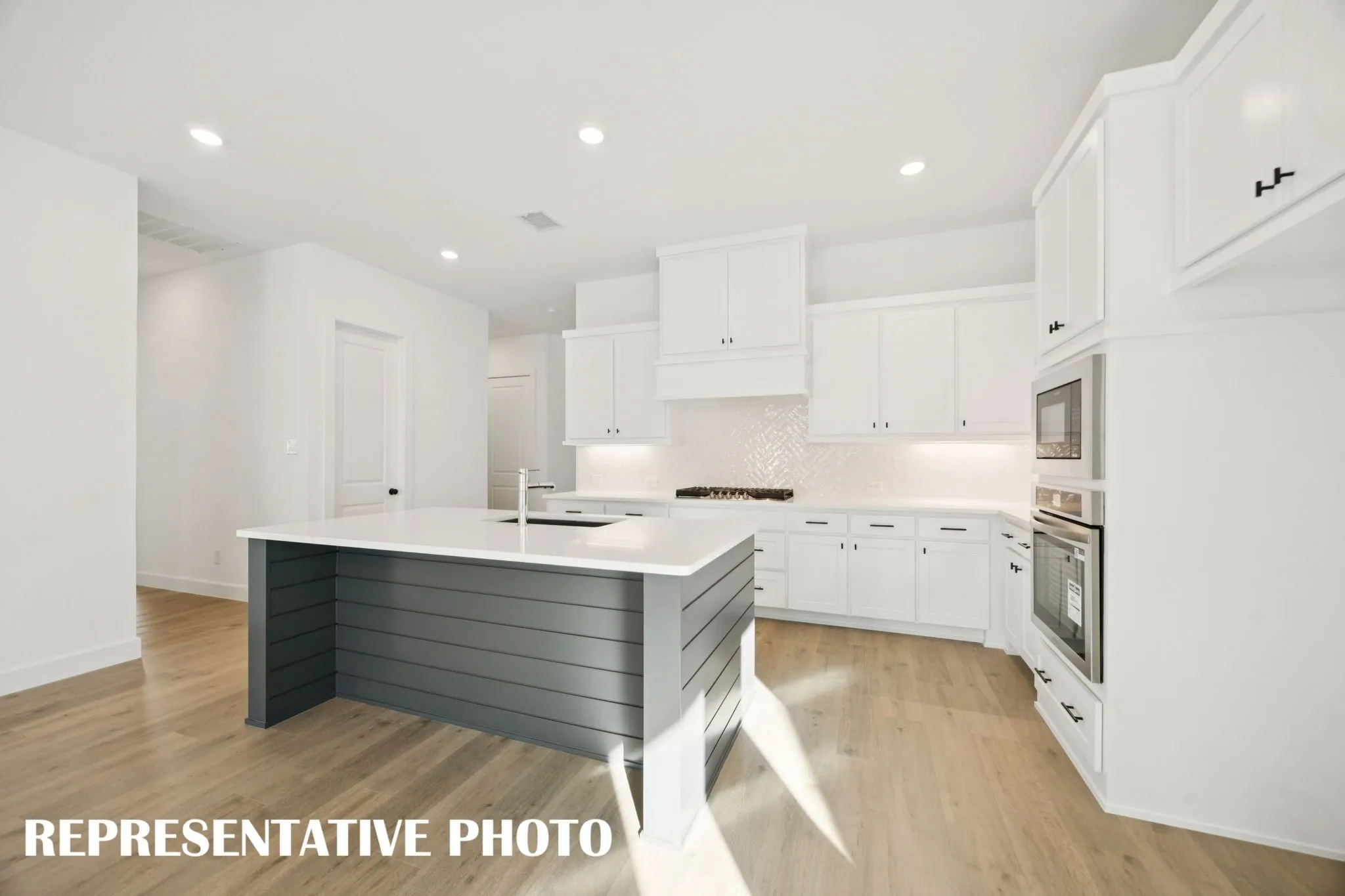 Beautiful cabinetry, gorgeous countertops and striking stainless steel create the kitchen of your dreams! REPRESENTATIVE PHOTO