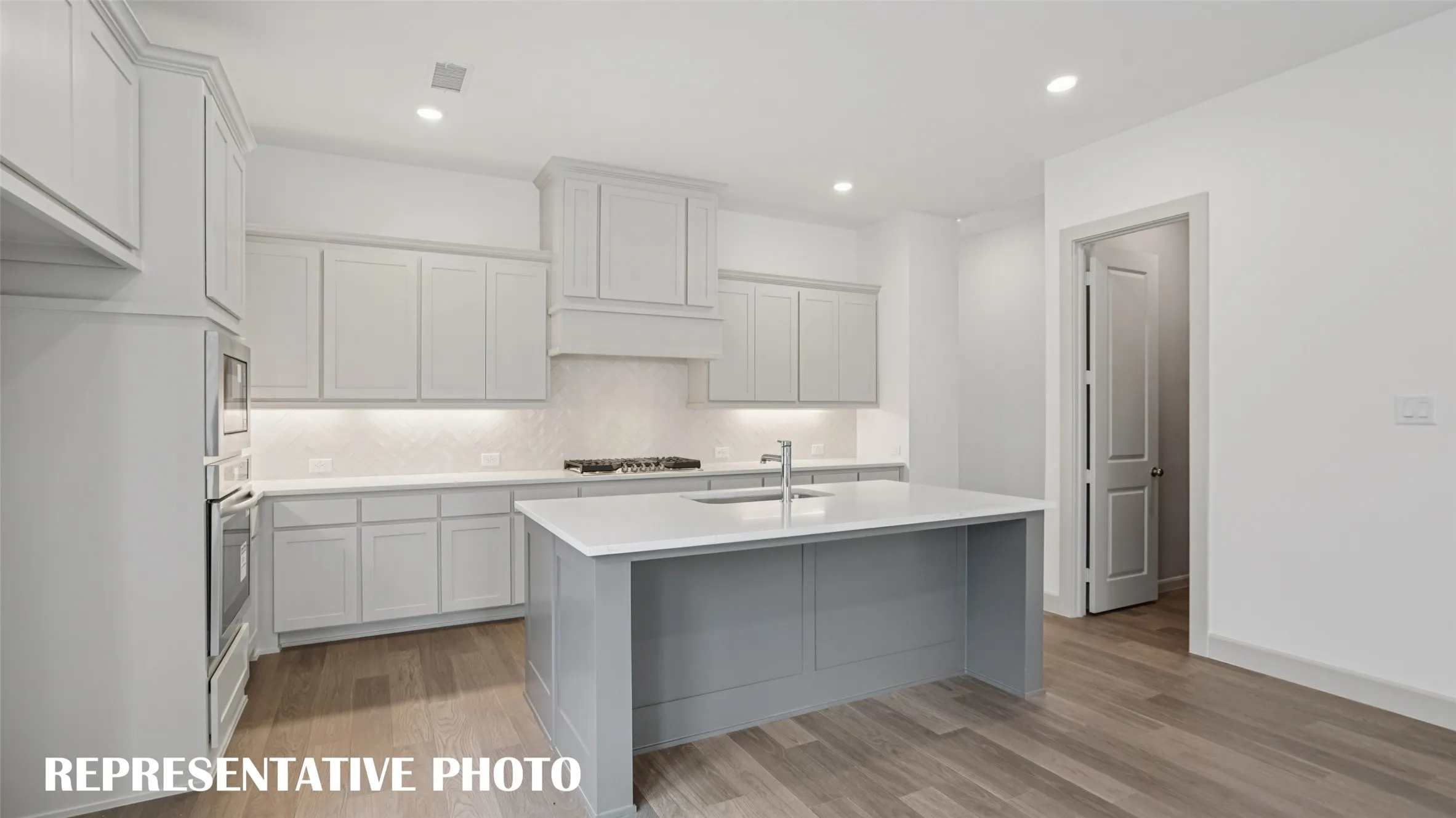 Your new dream home features a spacious kitchen island that is perfect for friends and family to gather round.  REPRESENTATIVE PHOTO