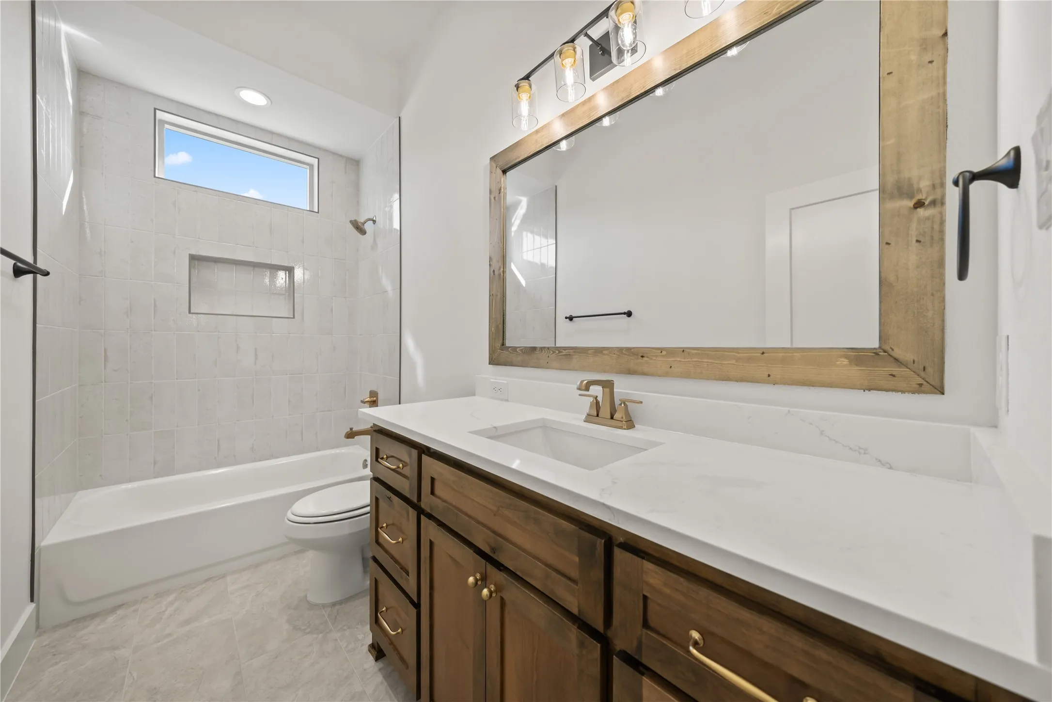Wood-finish vanity with a white countertop and rectangular sink