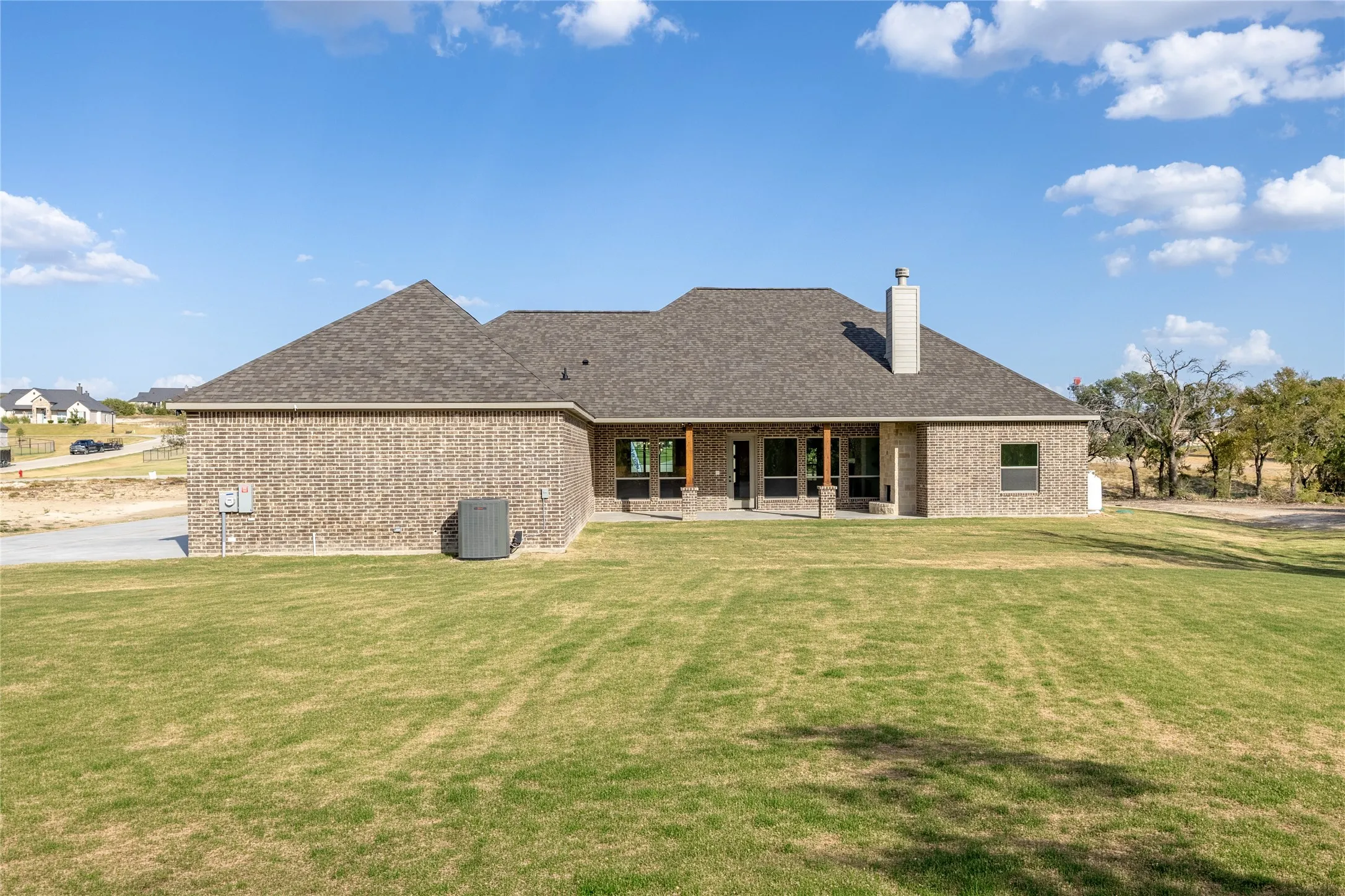 Brick exterior with a gabled roof and covered patio