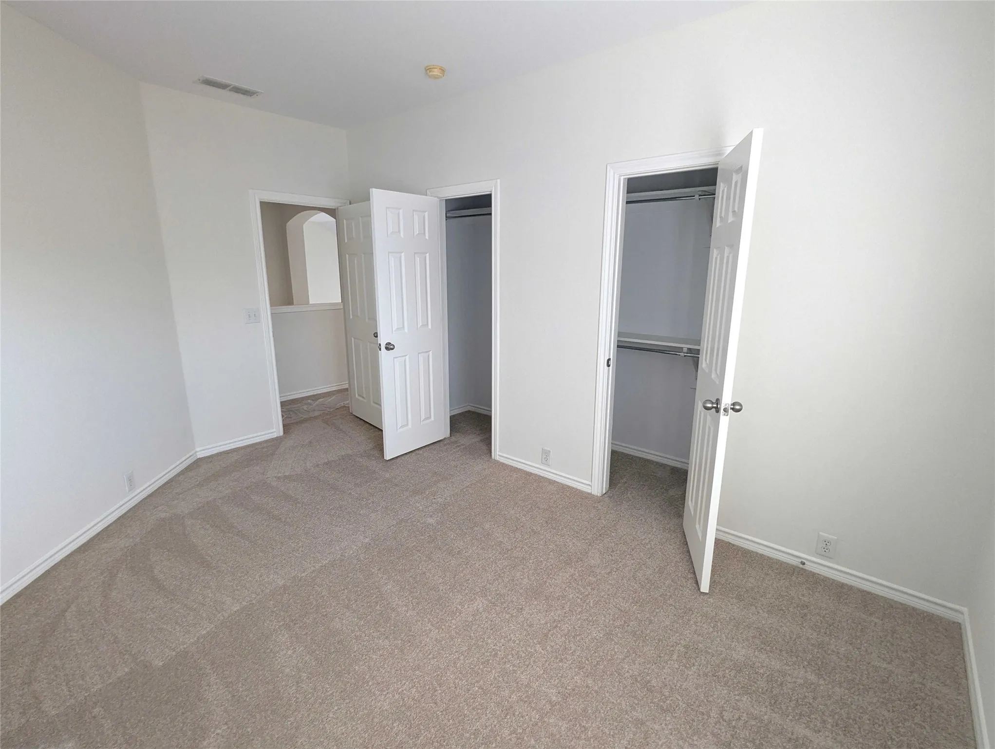 Plush carpeted flooring, two paneled closet doors, and recessed ceiling lighting