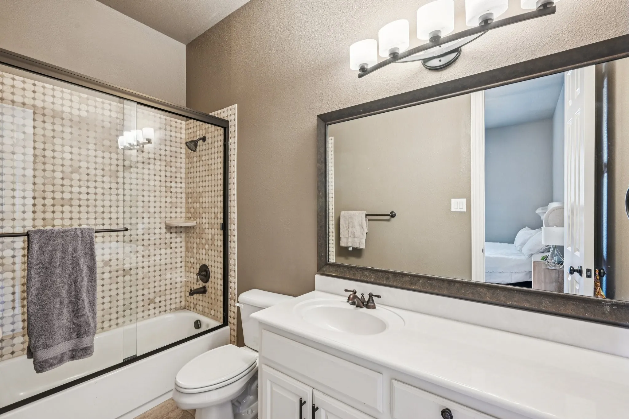 White vanity with an integrated sink and dark hardware