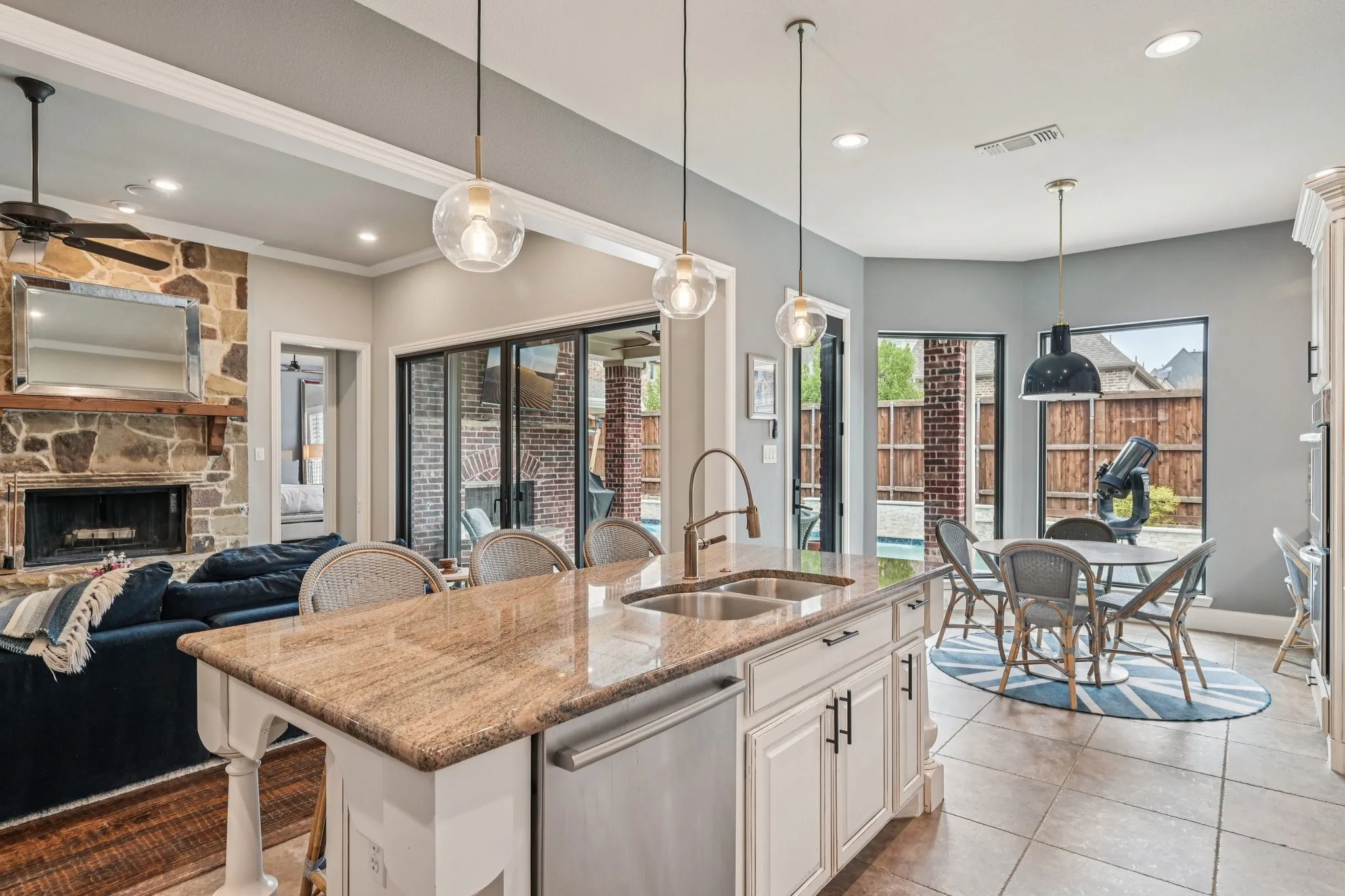 Kitchen island with a light-toned countertop and dual basin sink