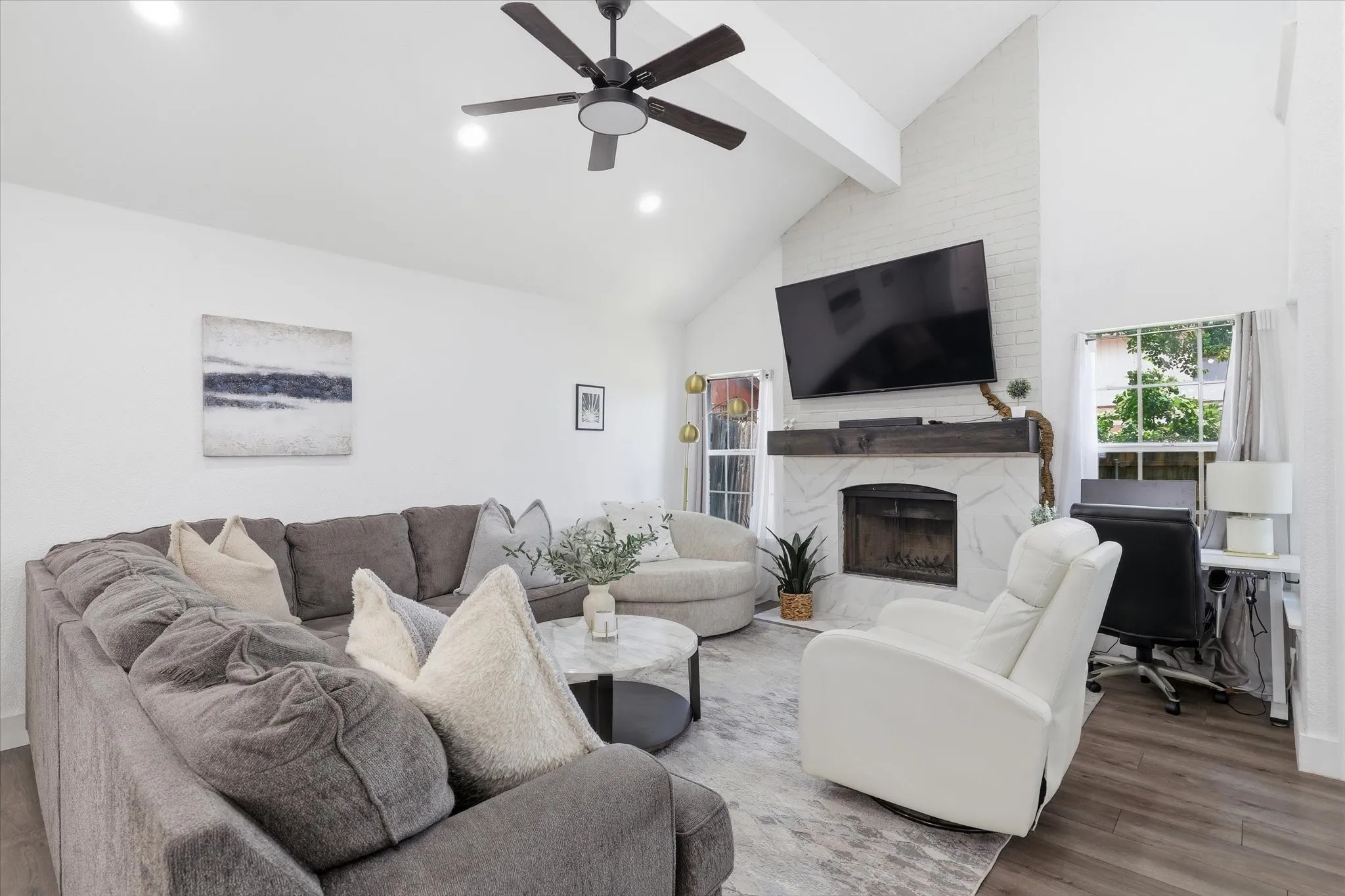 Vaulted ceiling with exposed beam, recessed lighting, and a ceiling fan