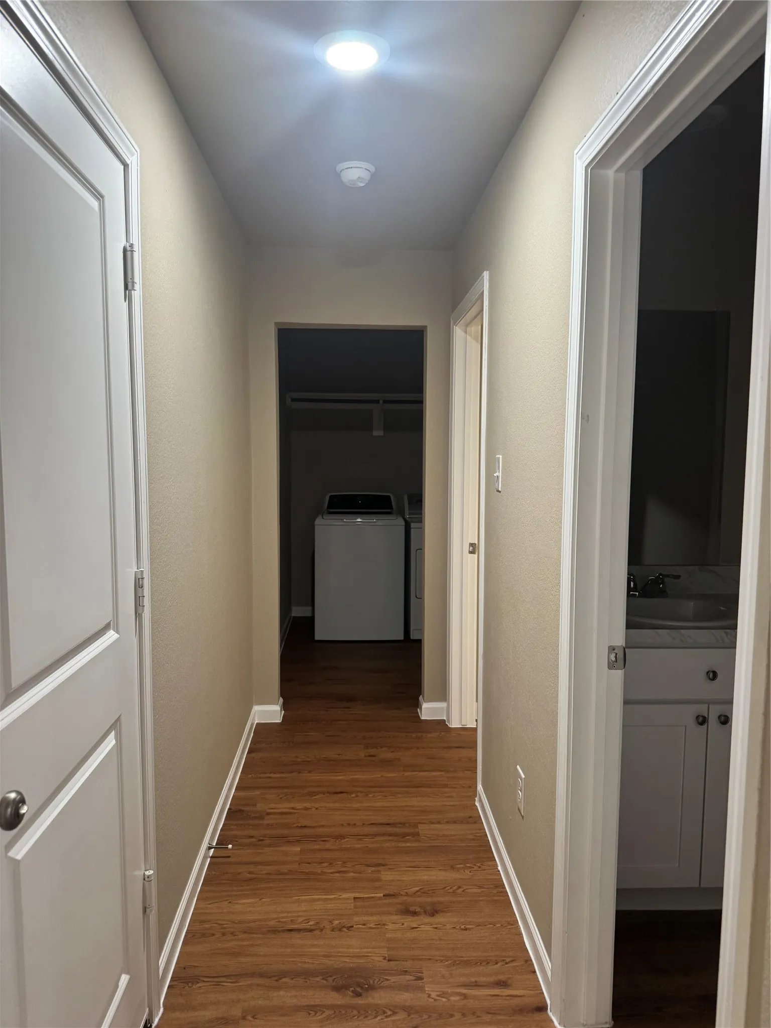 Hallway featuring wood-finish flooring, recessed lighting, and neutral wall tones