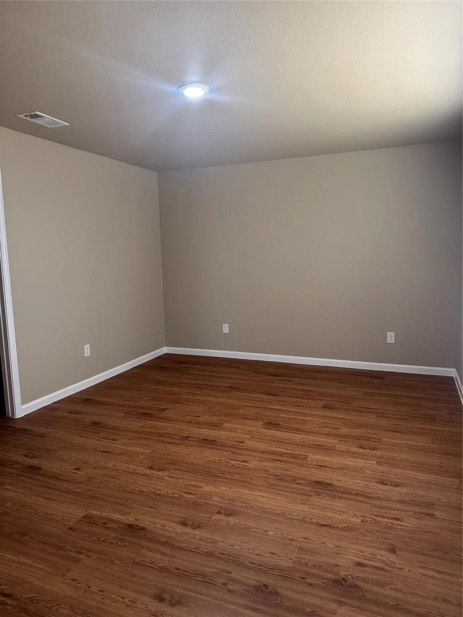 Wood-finish flooring with neutral wall paint and white trim