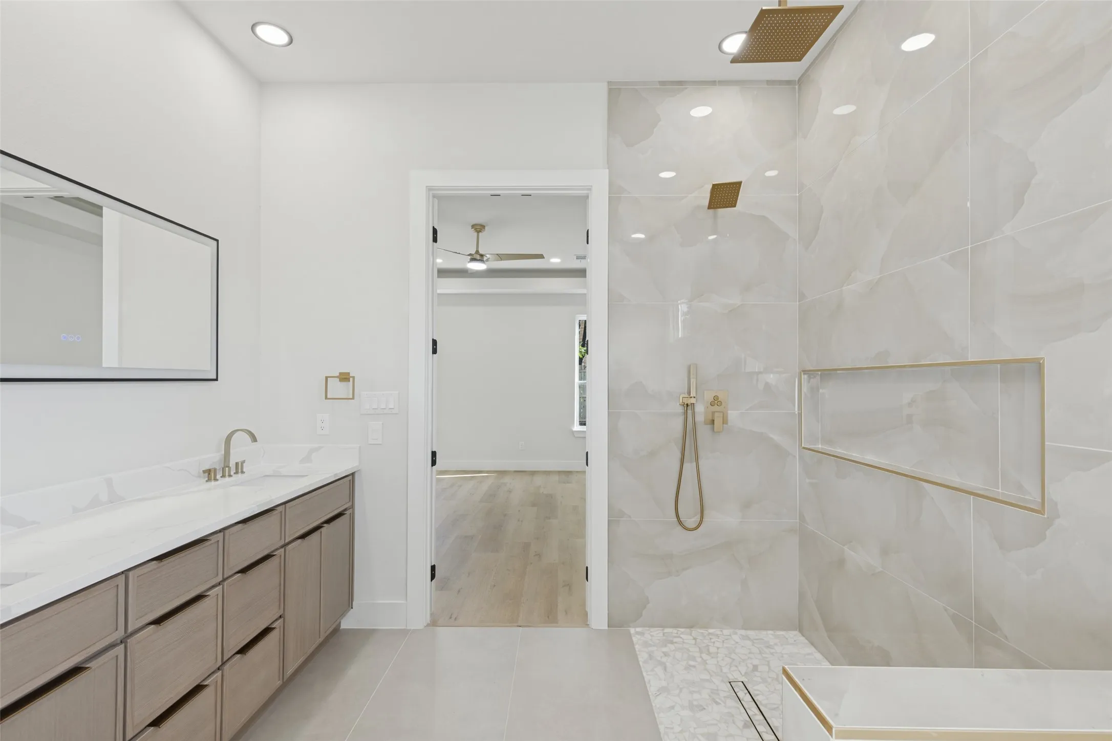 Dual vanity with undermount sinks, large rectangular mirror, and wood-finish cabinetry