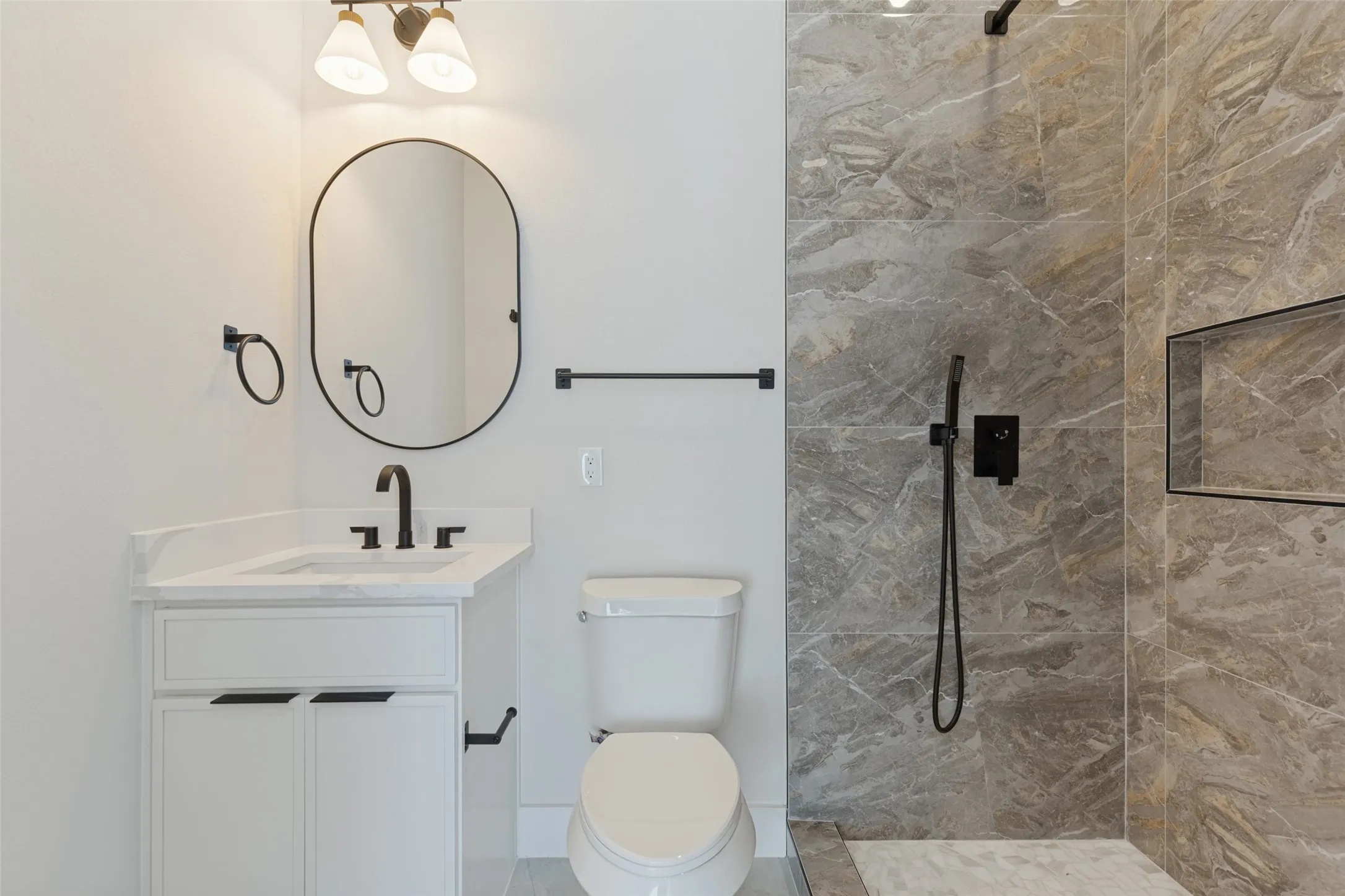 White vanity with an integrated sink and matte black fixtures