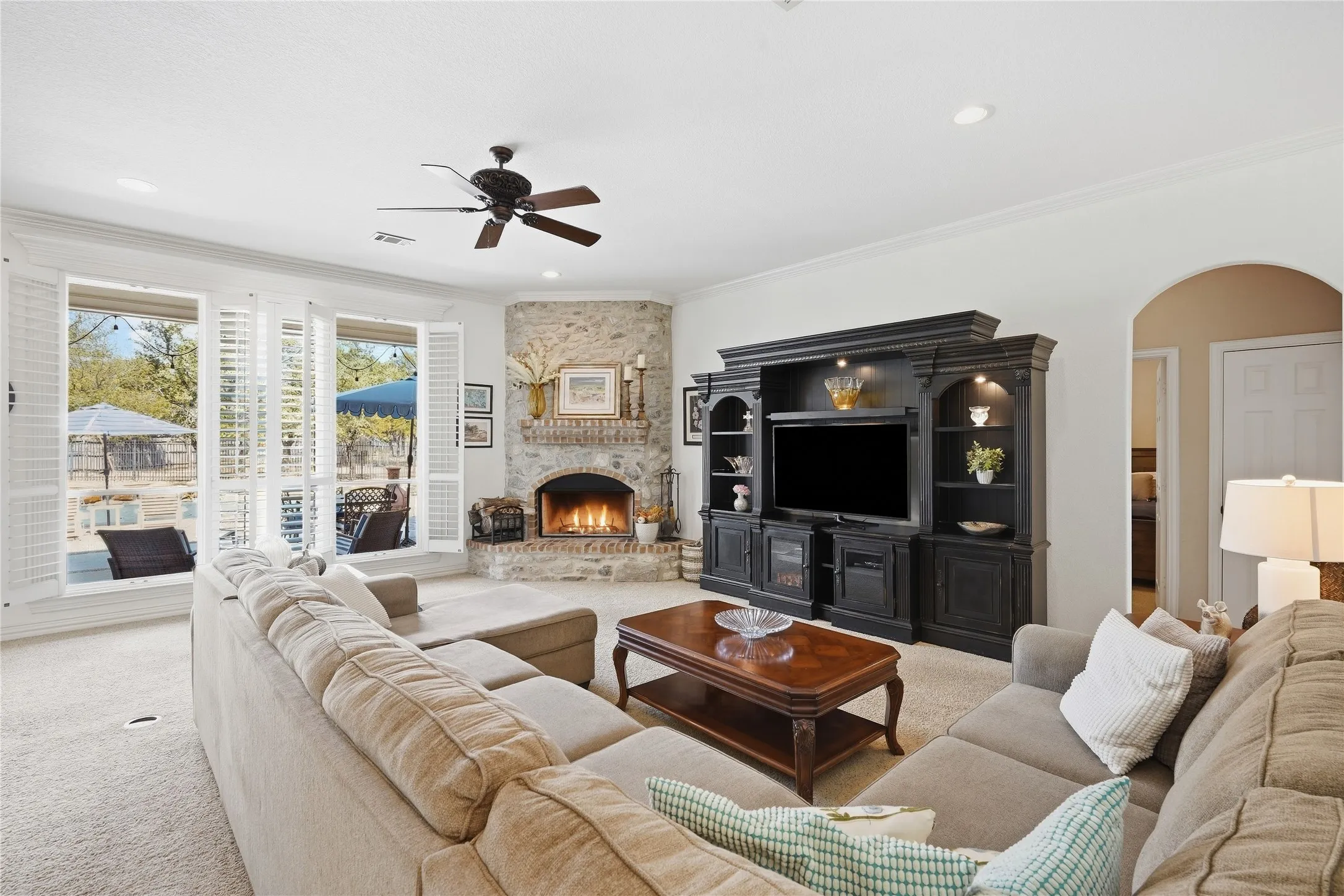 This spacious, light -filled living room oofers an inviting blend of comfort and warmth with the wood burning fireplace. The outdoor views are exquisite with the new windows (all windows replace 2026).