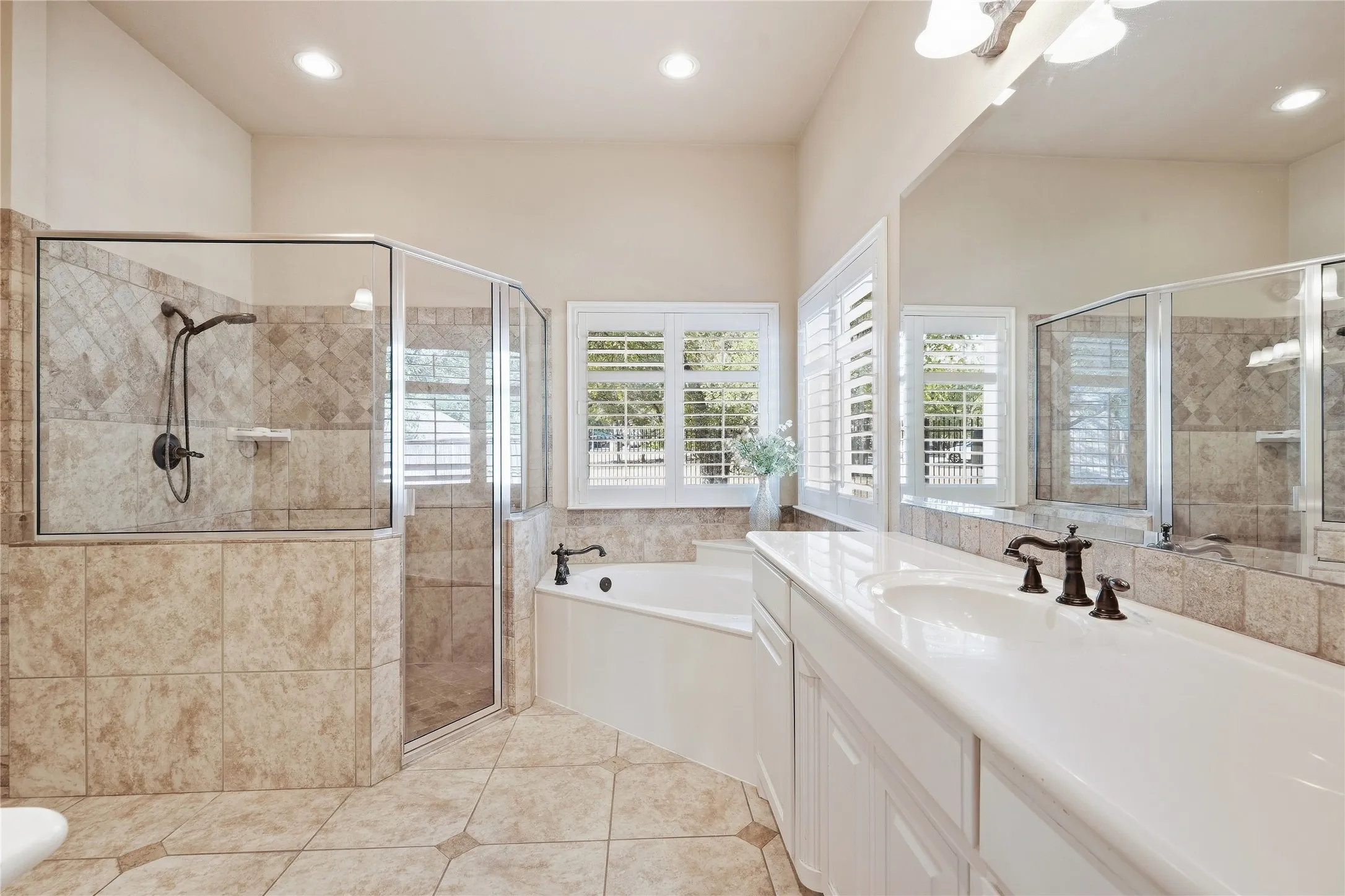 Outstanding bathroom duel sinks seperate vanities, tile flooring new windows with plantation shutters,jetted tub, seperate walk in shower and wait until you see the closet.