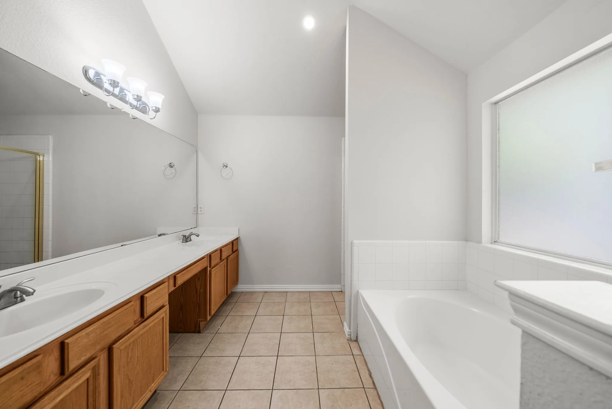 Dual vanity with wood-finish cabinetry and a single-basin sink