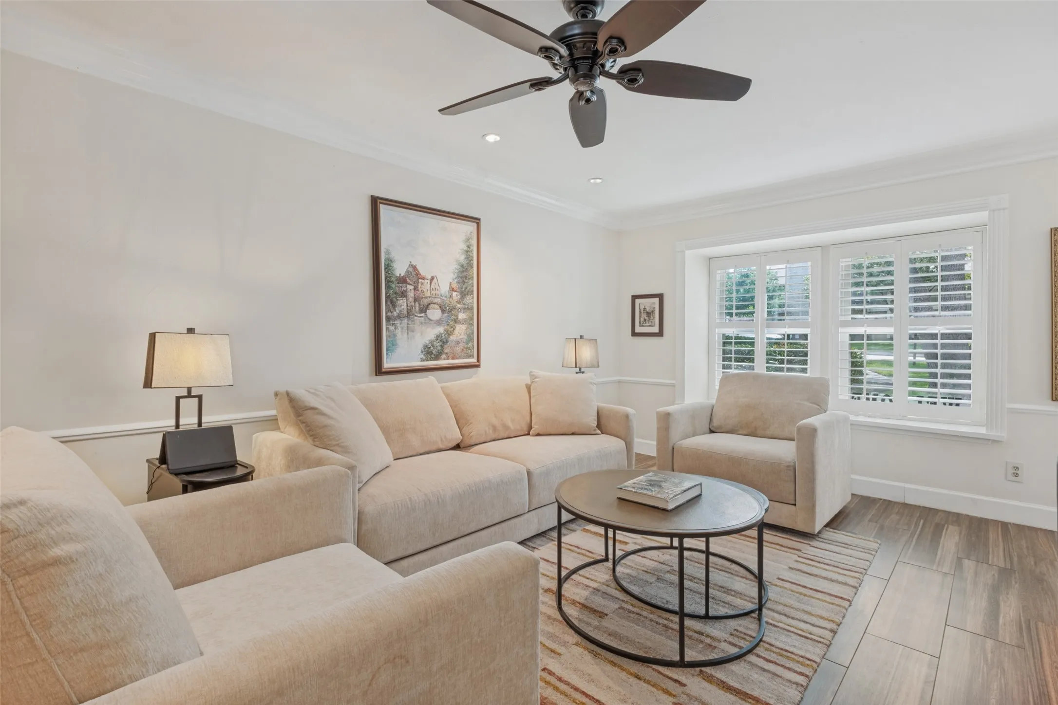 Crown molding, recessed lighting, wood-finish flooring, and a ceiling fan with integrated lighting