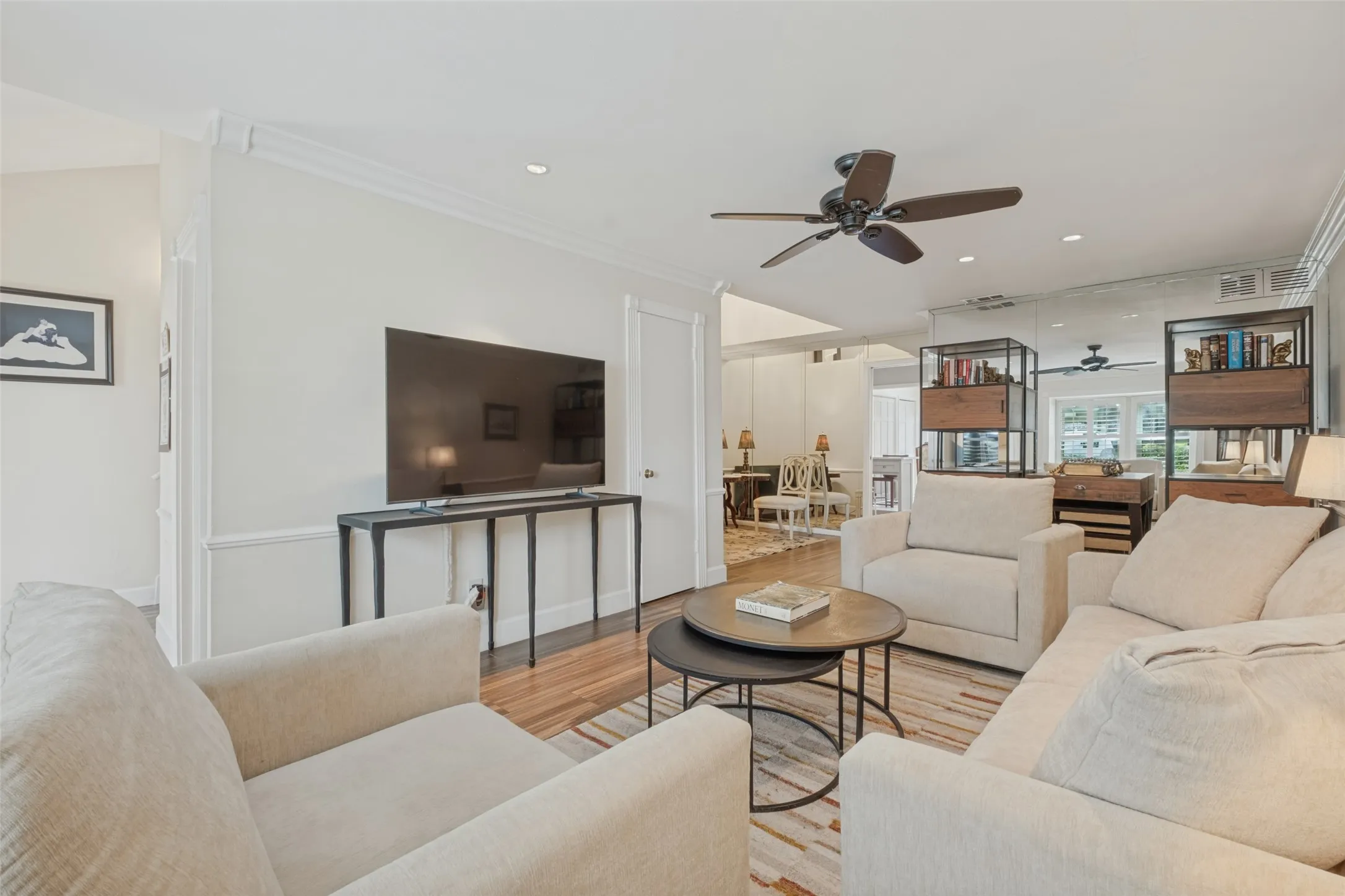 Recessed lighting, crown molding, wood-finish flooring, ceiling fan, and built-in shelving