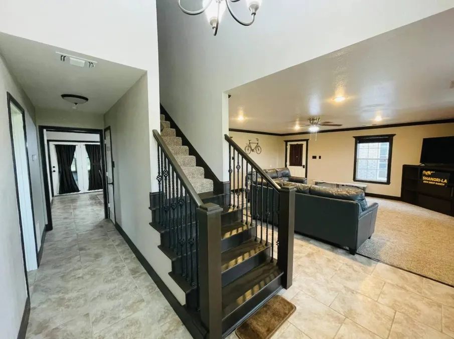 Staircase featuring dark wood finish and wrought iron balusters, tiled flooring, recessed lighting, and a ceiling fan
