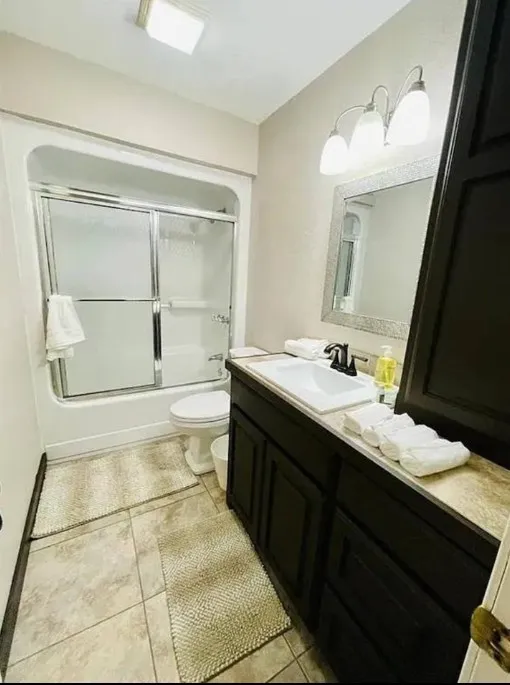 Tub and shower combination with sliding glass enclosure