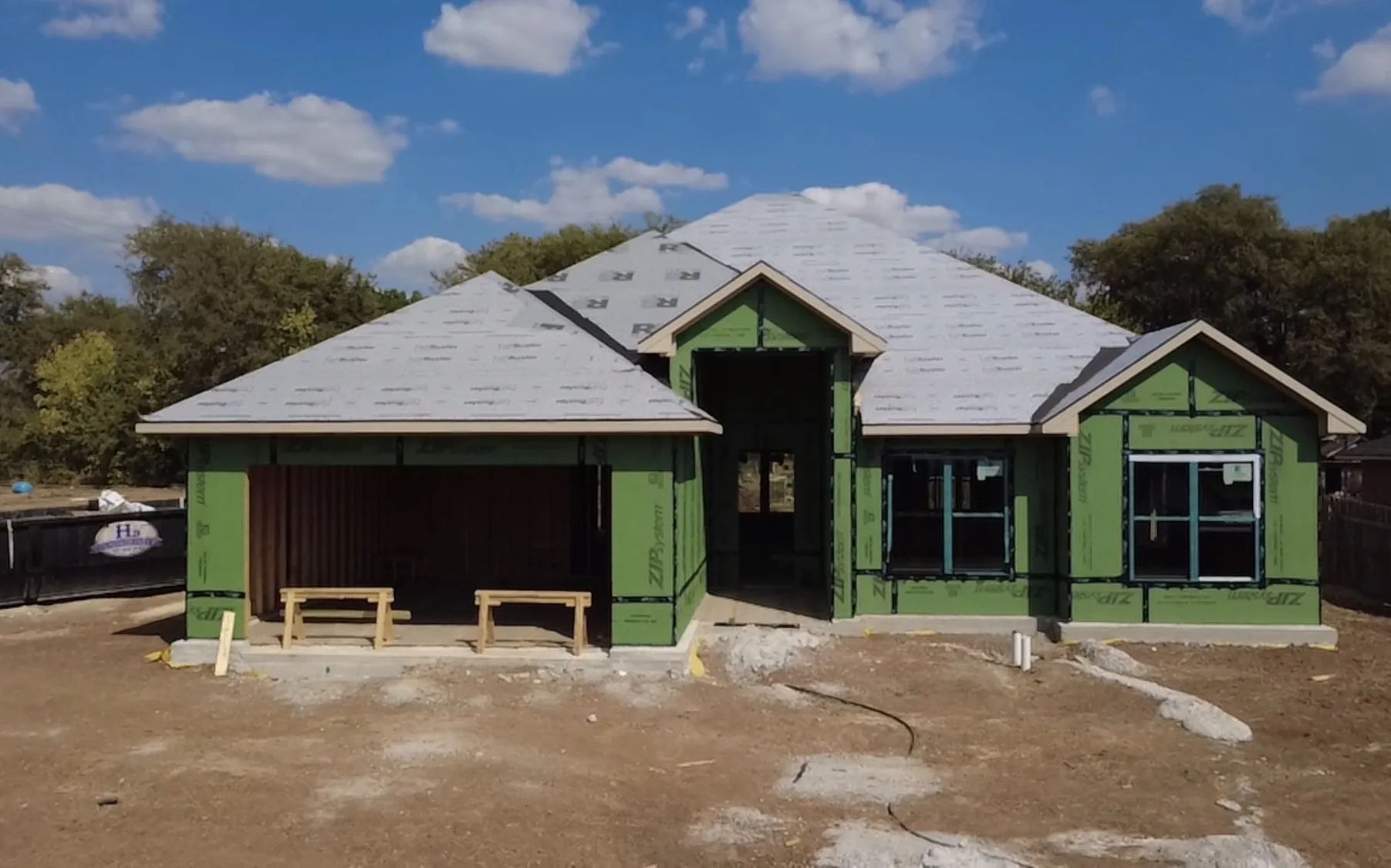 Pitched roofline, multiple gables, and framed window openings