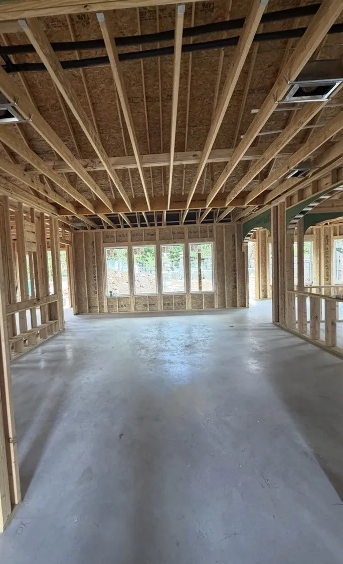 New construction framing with open floor plan and multiple window openings