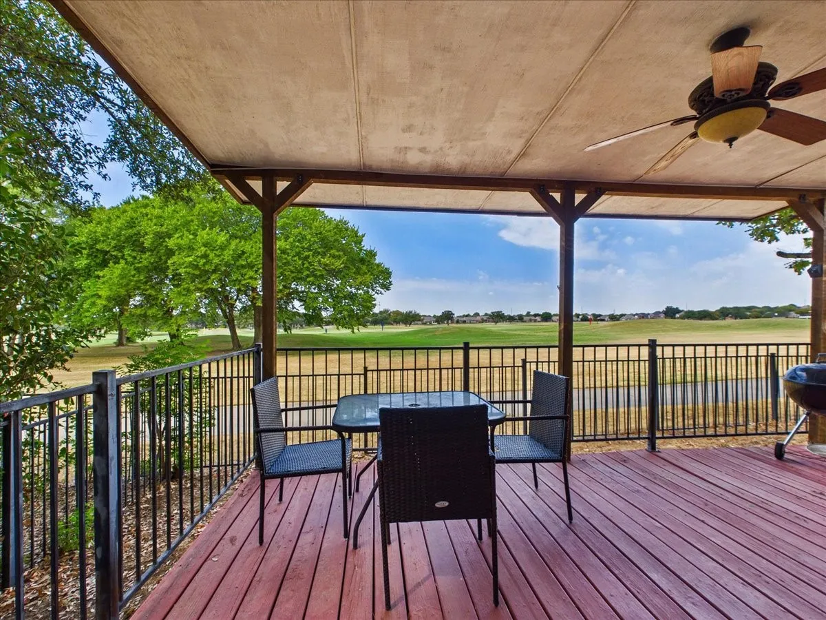Covered wood-finish deck with a ceiling fan