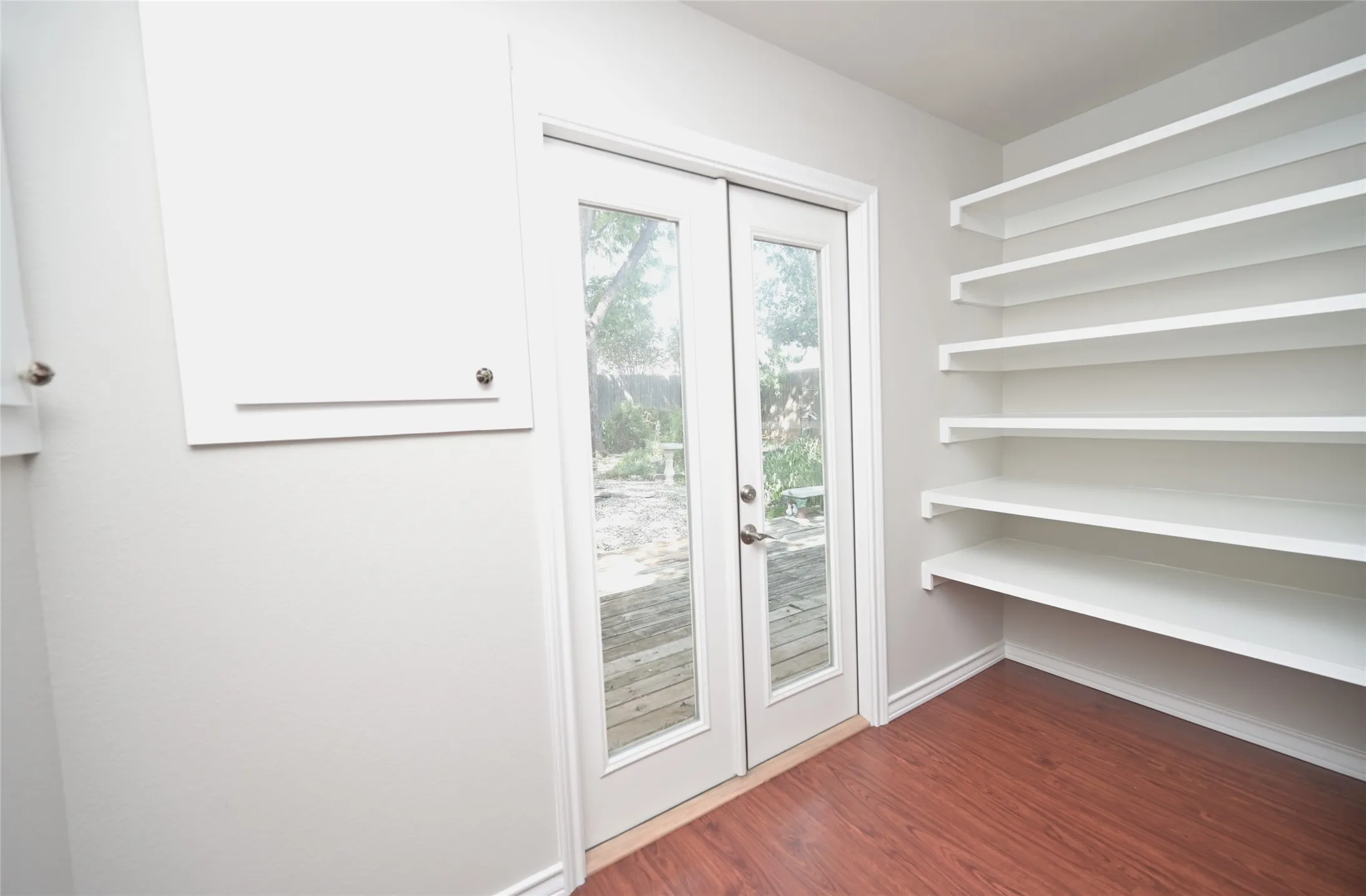 Double doors to backyard & side built-ins