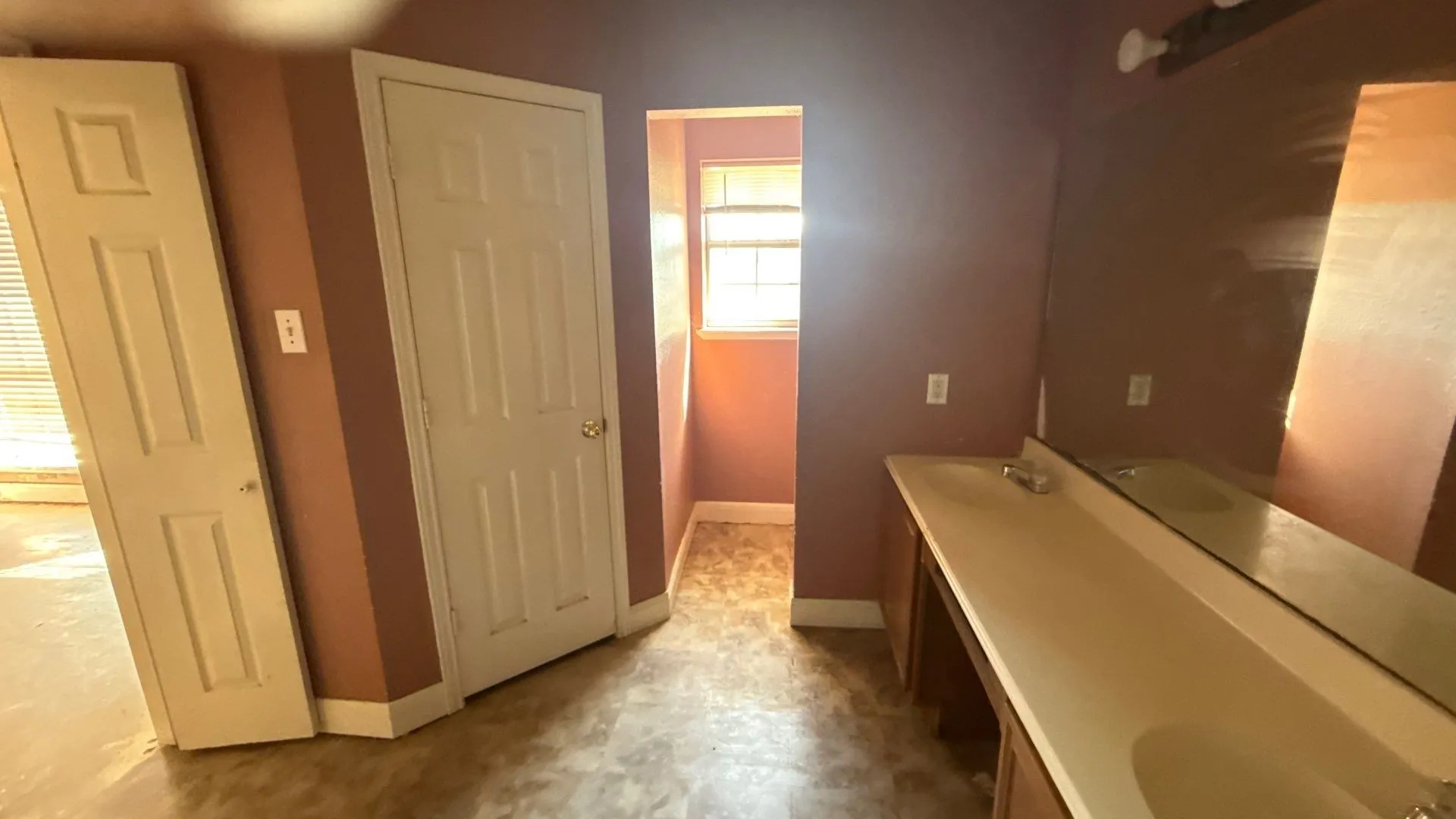 Primary Bathroom with Double vanity, integrated sinks and expansive wall mirror