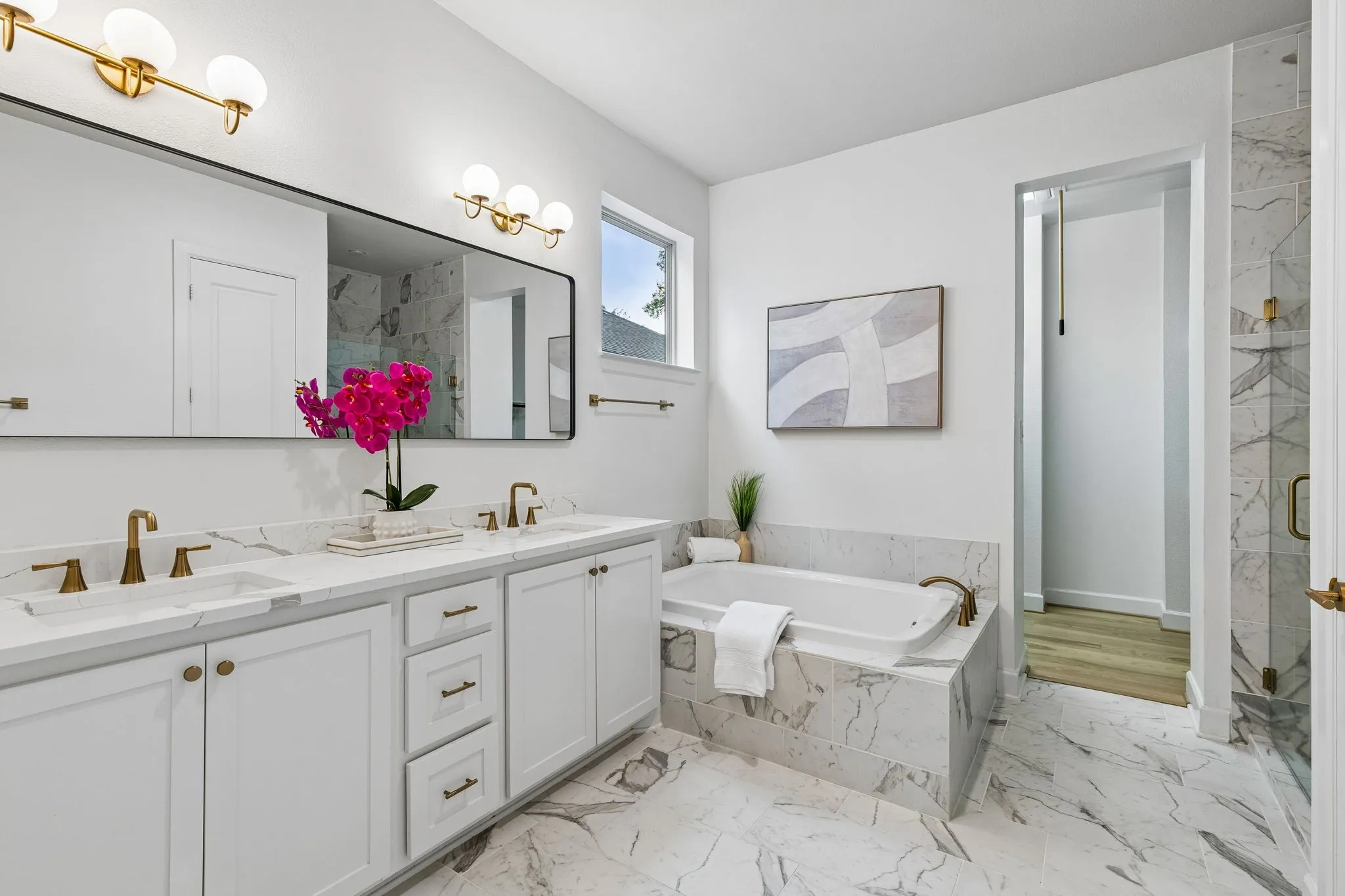 Dual Calacatta quartz vanity with white cabinetry and integrated sinks