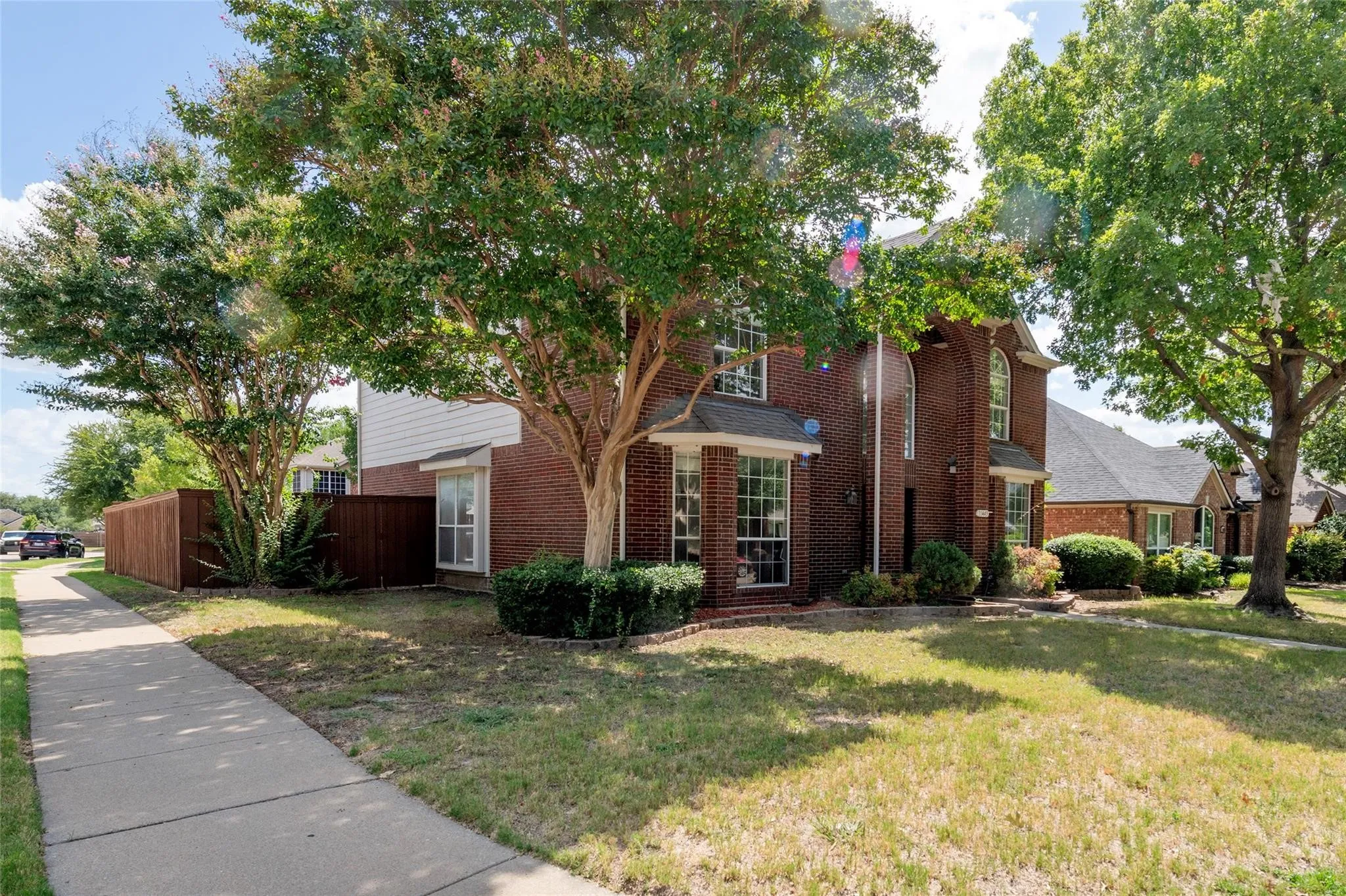 Traditional brick exterior featuring a multi-level design and arched windows