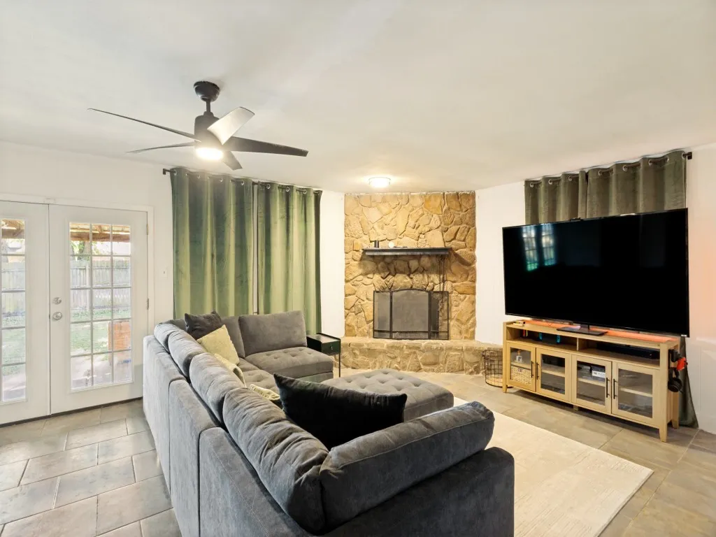 Stone-clad fireplace feature with built-in hearth