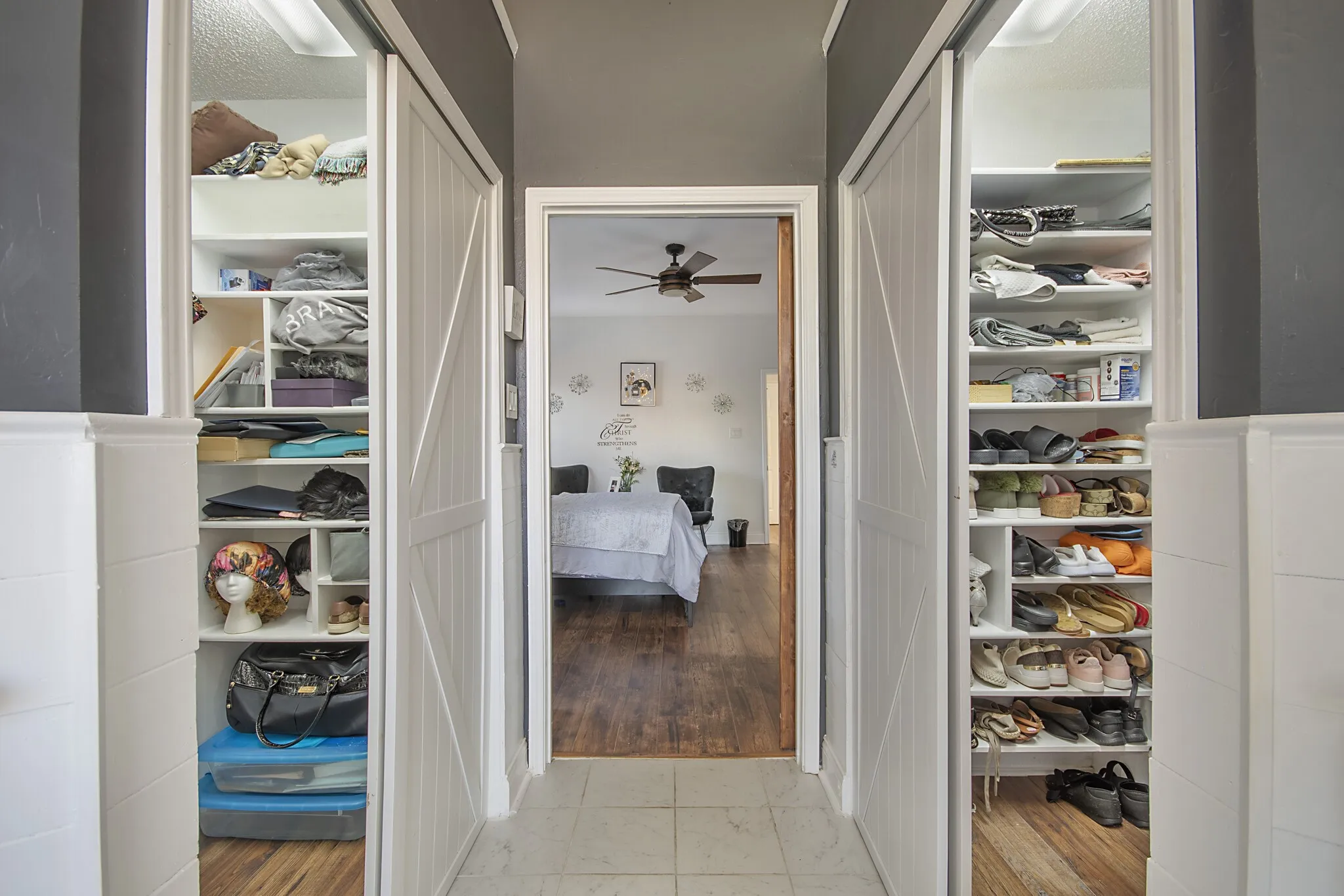 Primary walk-in closet, built out floor to ceiling and opening to the bedroom.