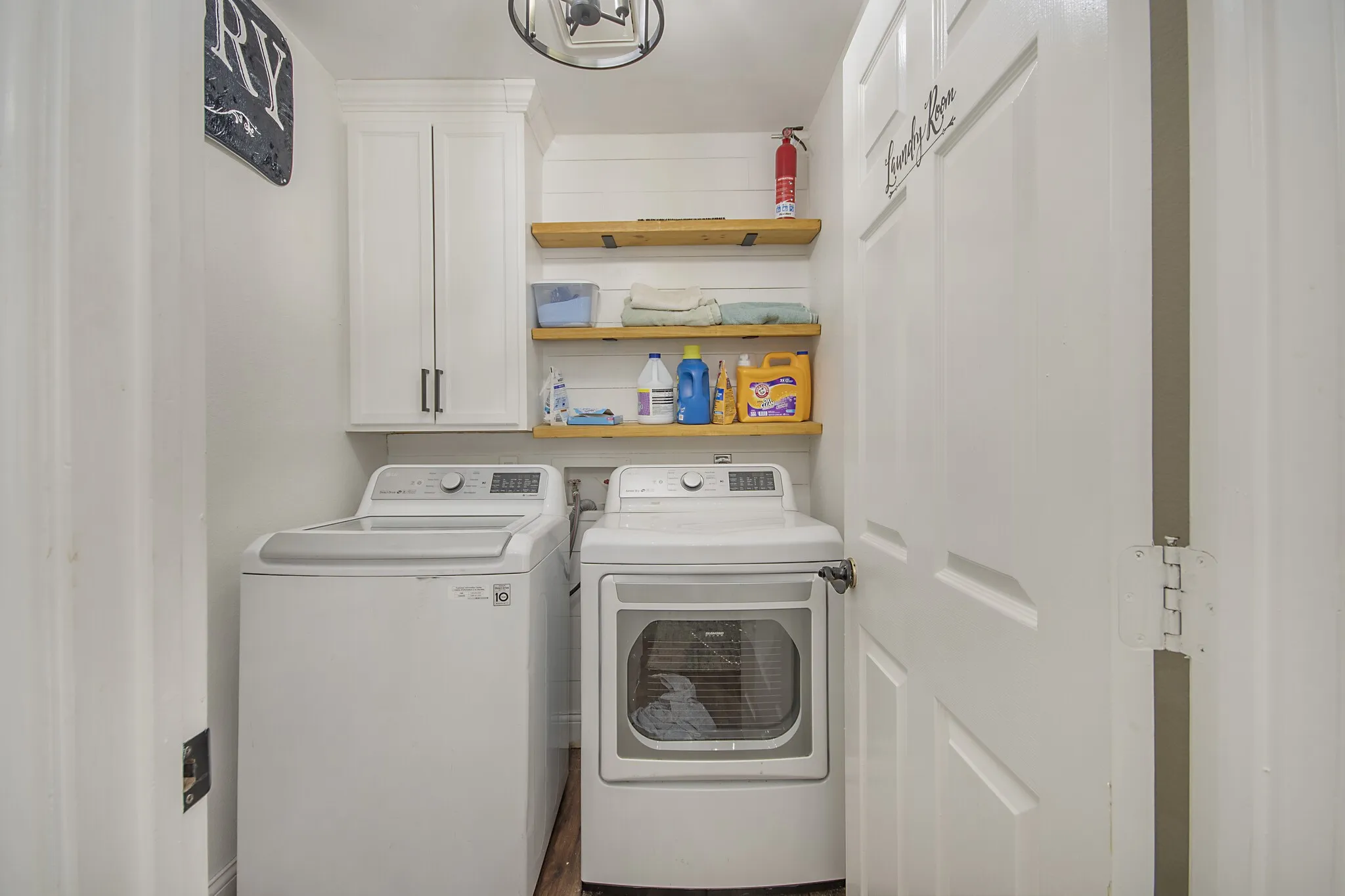 Utility room with full-size washer and dryer, which convey.